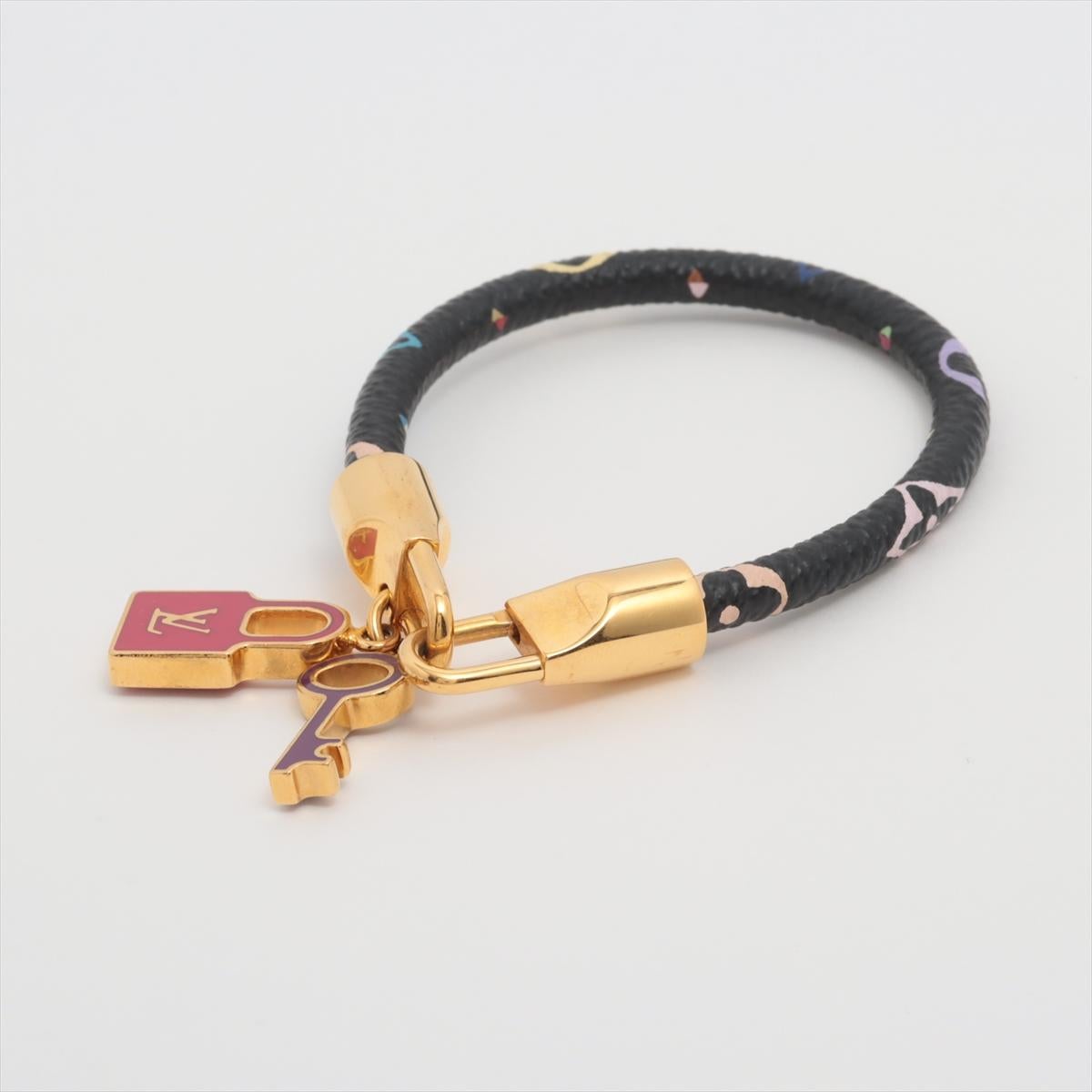The Louis Vuitton Monogram Lock It Bracelet in Multicolor Black is a statement accessory that exudes luxury and sophistication. Crafted from the iconic Monogram canvas, the bracelet features vibrant multicolor LV initials against a sleek black