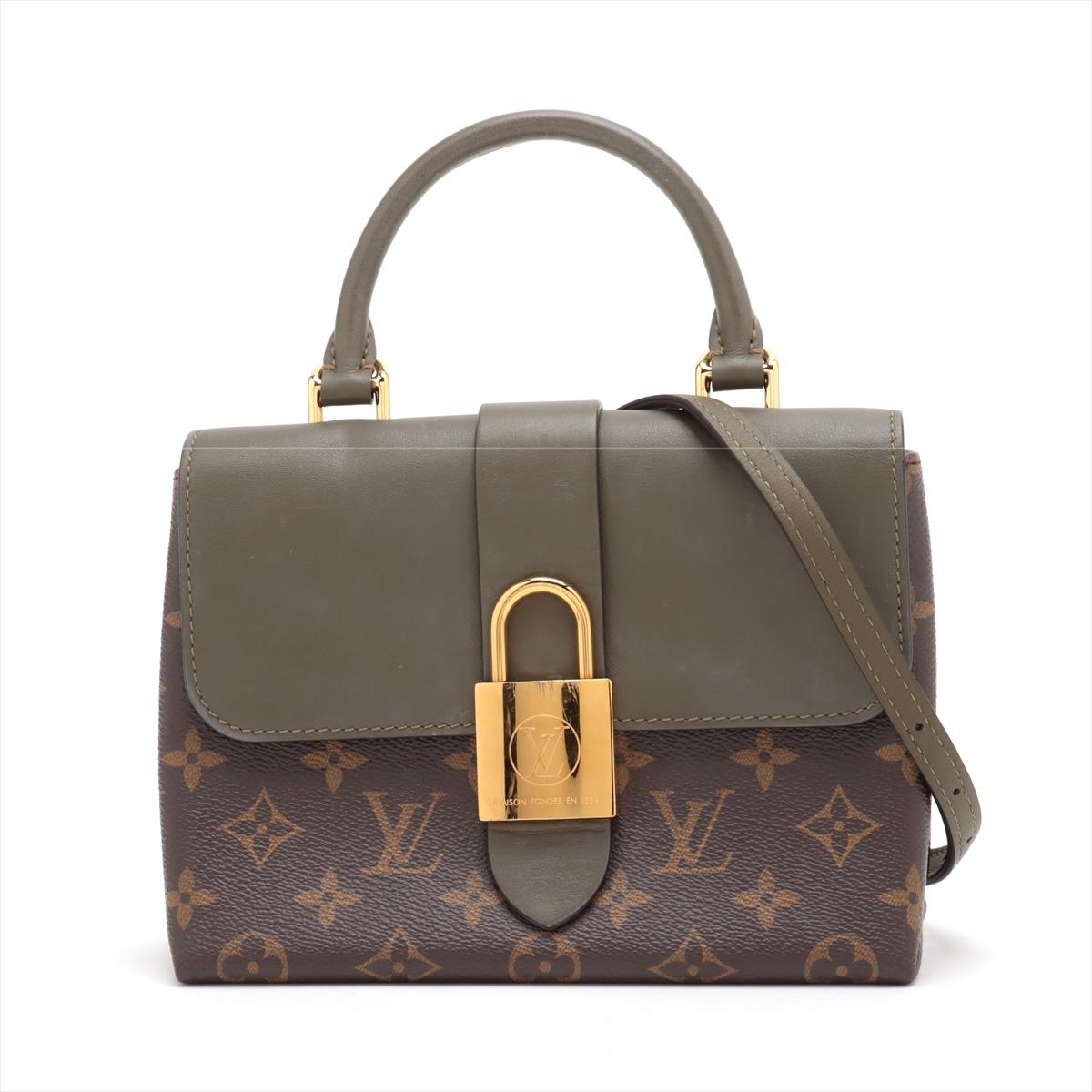 The Louis Vuitton Monogram Locky BB Handbag in Brown Khaki a chic and distinctive addition to the Monogram canvas collection, showcasing a fusion of luxury and contemporary design. The Locky BB features iconic Monogram canvas adorned with a unique
