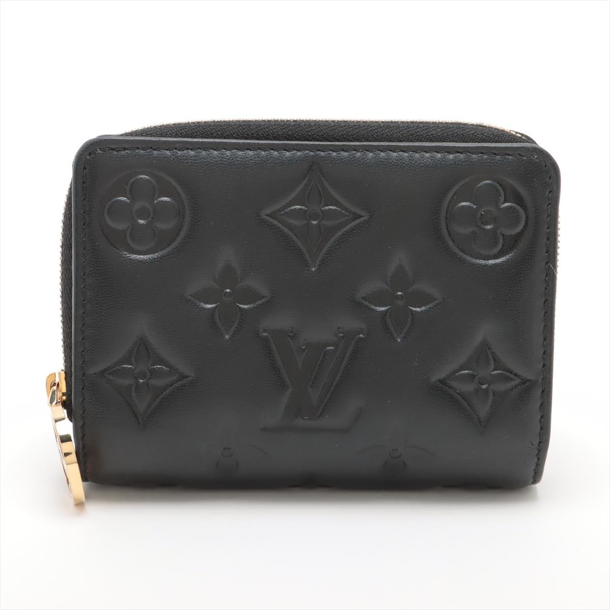 The Louis Vuitton Monogram Lou Coussin Wallet in Black is a sophisticated and modern accessory that seamlessly blends elegance with functionality. Crafted from luxurious black leather, it features an embossed Monogram pattern, giving it a sleek and