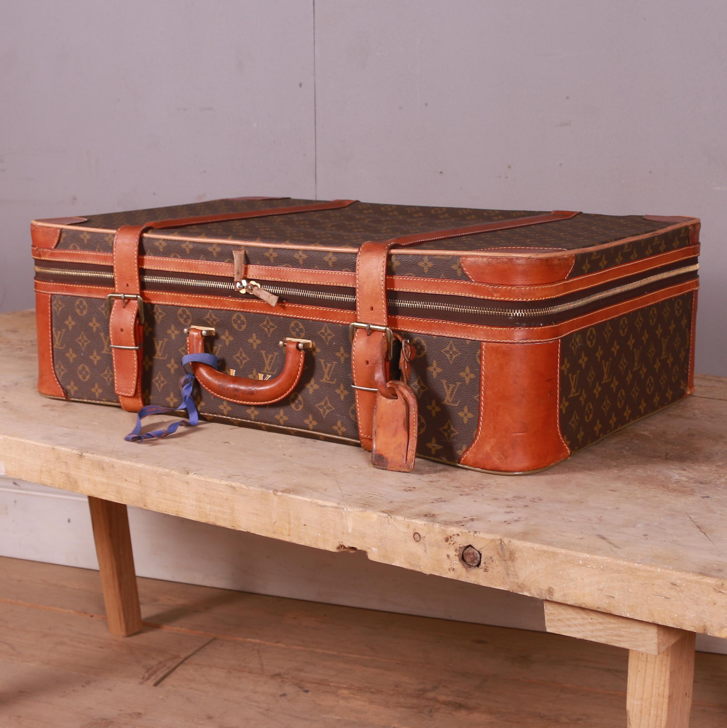 A vintage Louis Vuitton leather monogram suitcase initialed with 