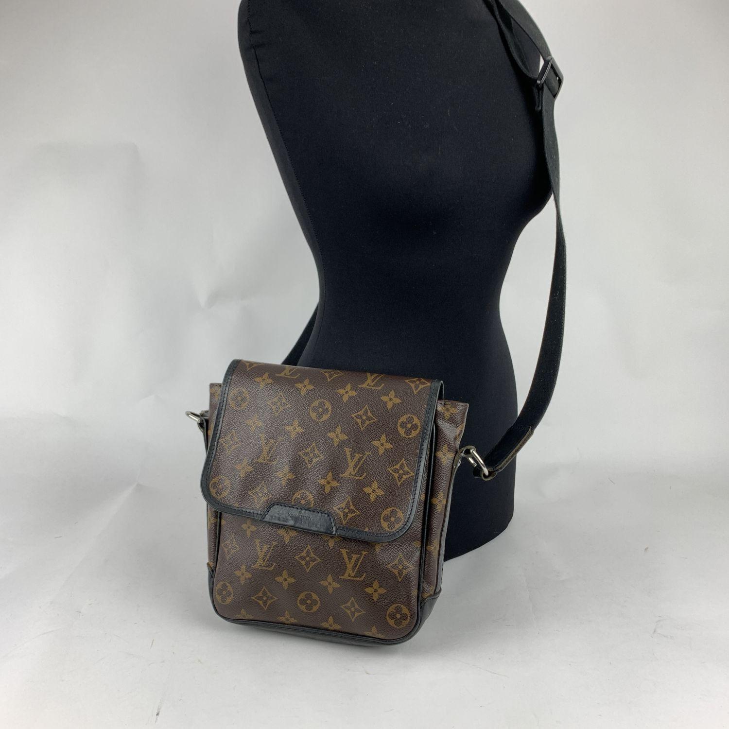 Louis Vuitton 'Macassar Bass PM' Crossbody Bag, crafted in monogram canvas with black leather trim. The exterior features a flap front closure. Burgundy canvas lining. 1 side open pocket inside. Adjustable black nylon shoulder strap. 'LOUIS VUITTON