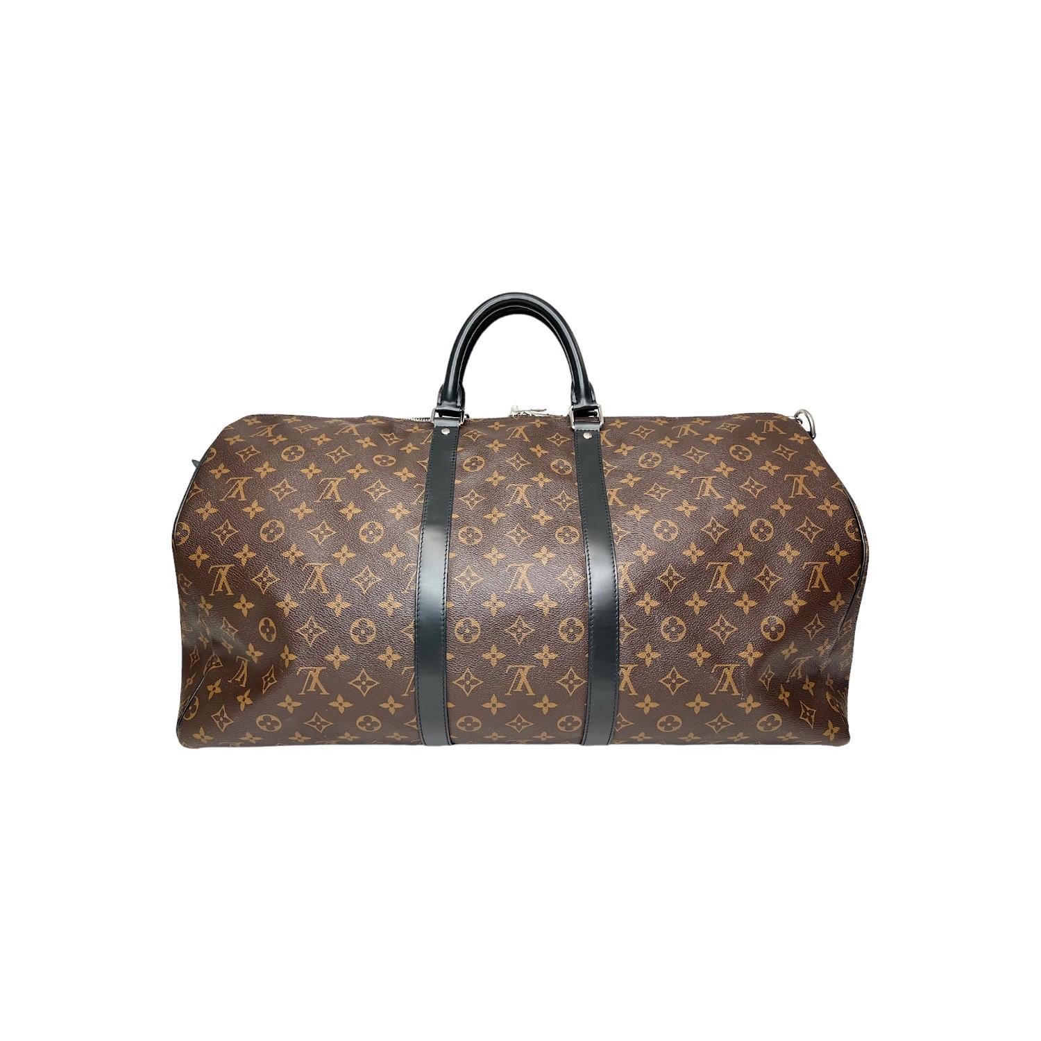 his Louis Vuitton Macassar Keepall Bandoulière 55 travel bag was made in the 6th week of 2021 in France and it is finely crafted of the classic Louis Vuitton Monogram canvas exterior with black leather trimmings and silver-tone hardware features. It