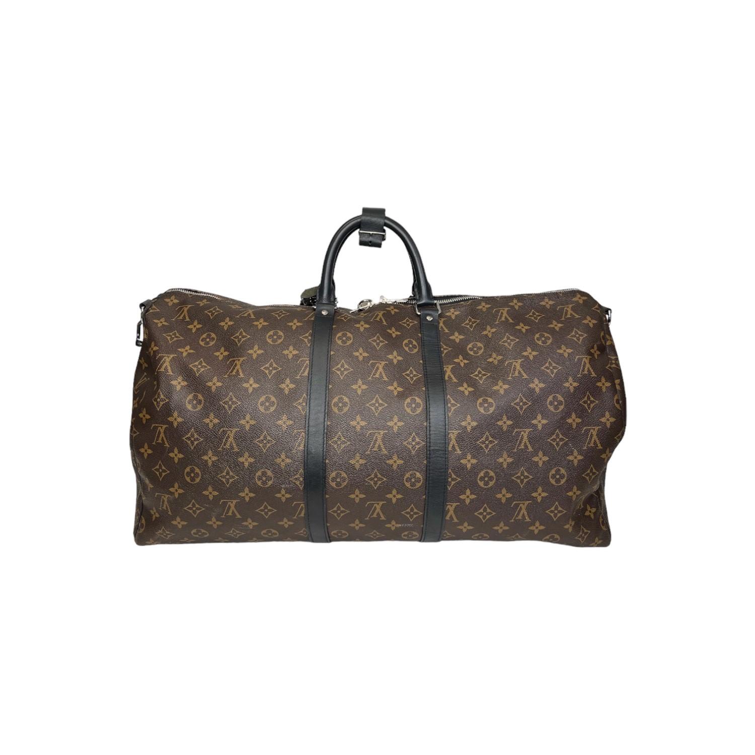 This Louis Vuitton Monogram Macassar Keepall Bandoulière 55 travel bag was made in the 40th week of 2018 in France and it is finely crafted of the classic Louis Vuitton Monogram Macassar canvas exterior with black leather trimming and silver-tone