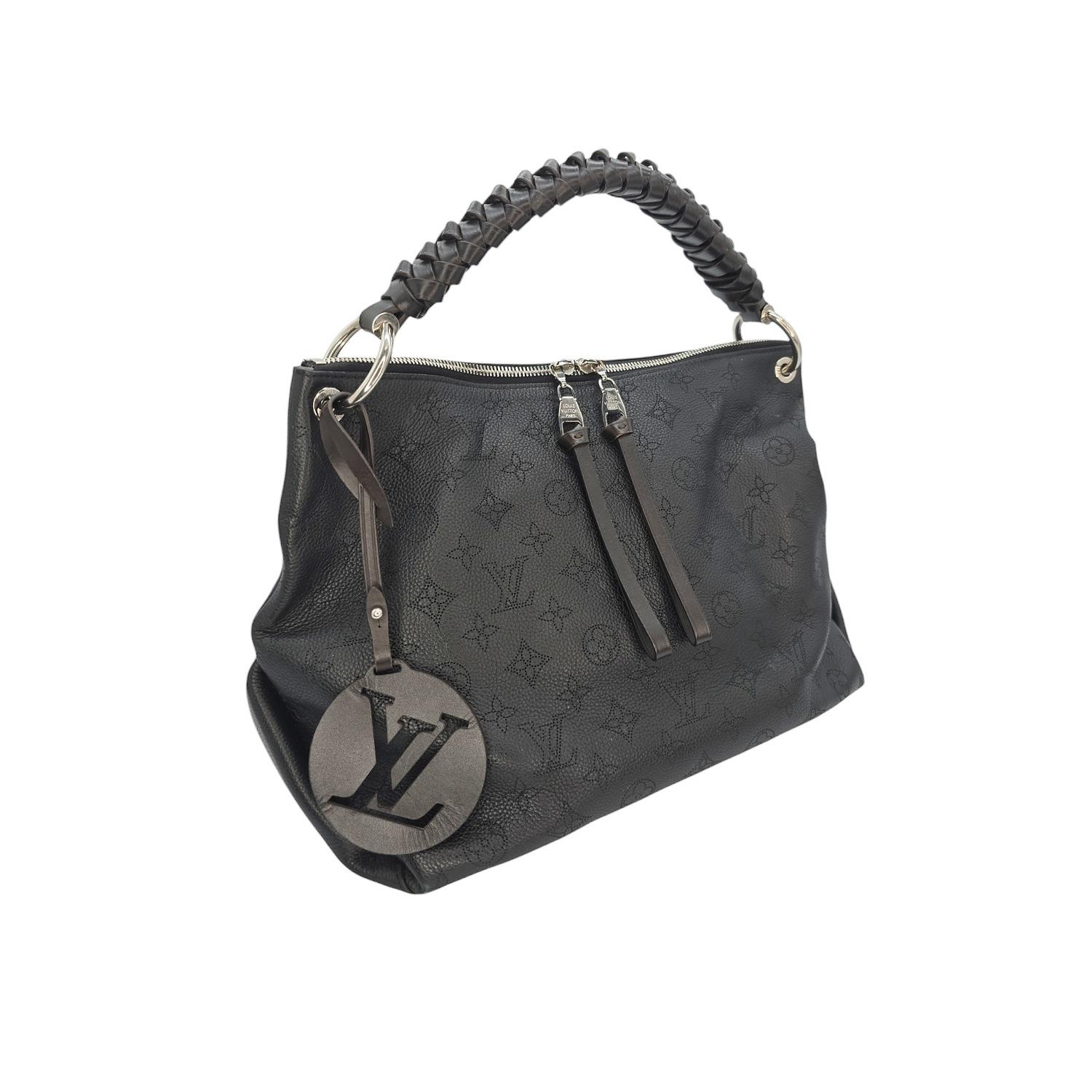 Elevate your style with the Louis Vuitton Mahina Beaubourg MM Hobo. Designed with exquisite mahina perforated calf leather, this black shoulder bag boasts a smooth Espresso leather braided top handle and polished silver hardware. The spacious