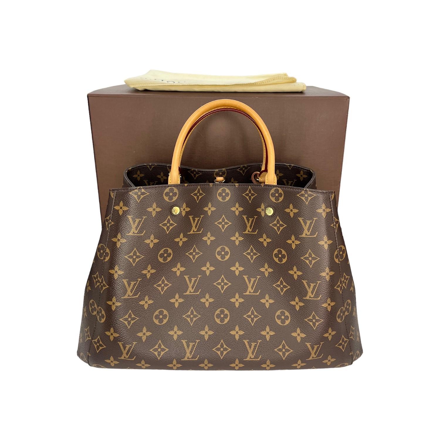 This Louis Vuitton Montaigne GM was made in the USA and it is finely crafted of the Louis Vuitton Monogram coated canvas with leather trimming and gold-tone hardware features. It has rolled leather top handles. It features a clasp closure that opens