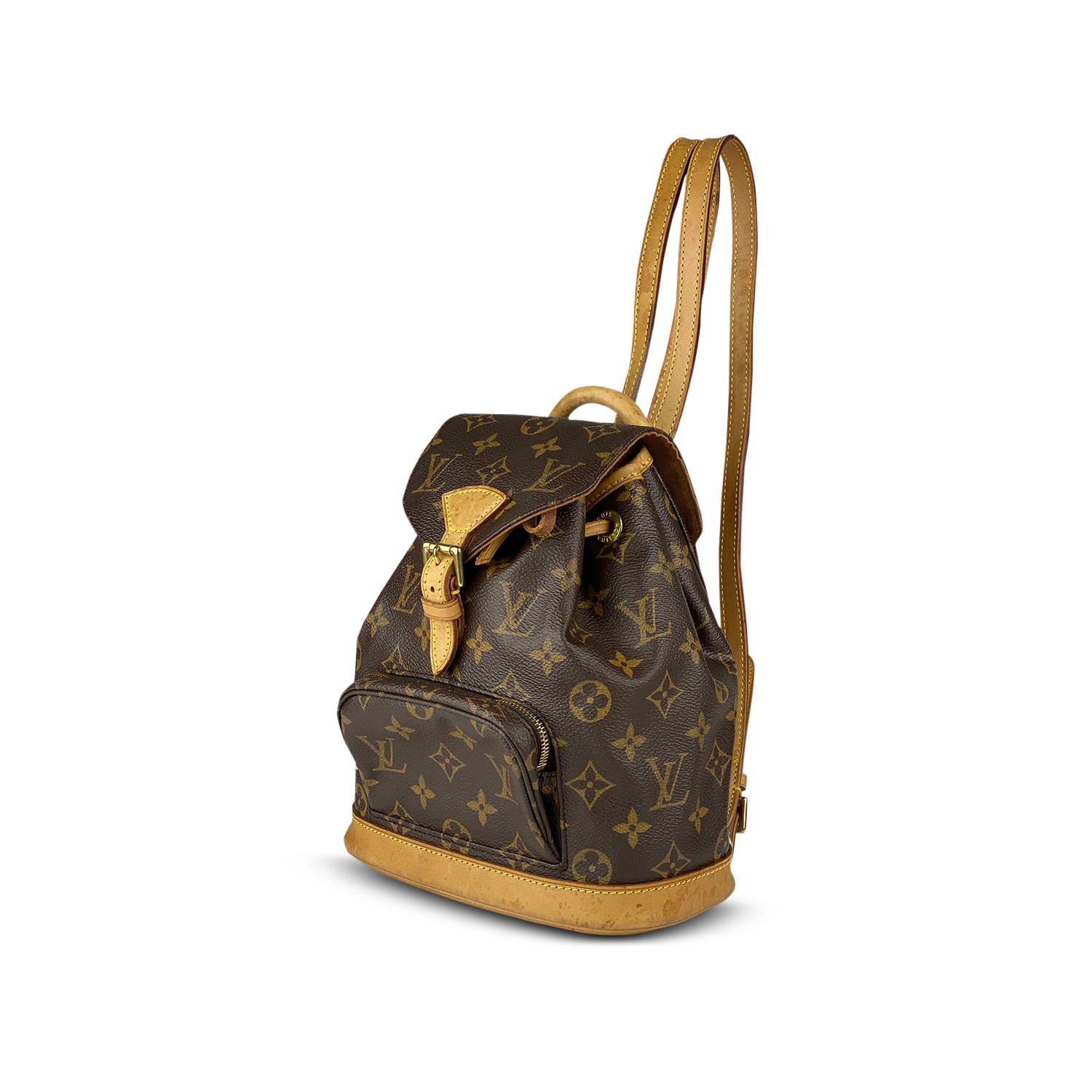 Brown and tan monogram coated canvas Louis Vuitton Montsouris PM with

- Brass-tone hardware
- Tan Vachetta leather trim
- Single rolled top metal handle
- Dual flat shoulder straps with buckle adjustment, single exterior zip pocket, brown canvas