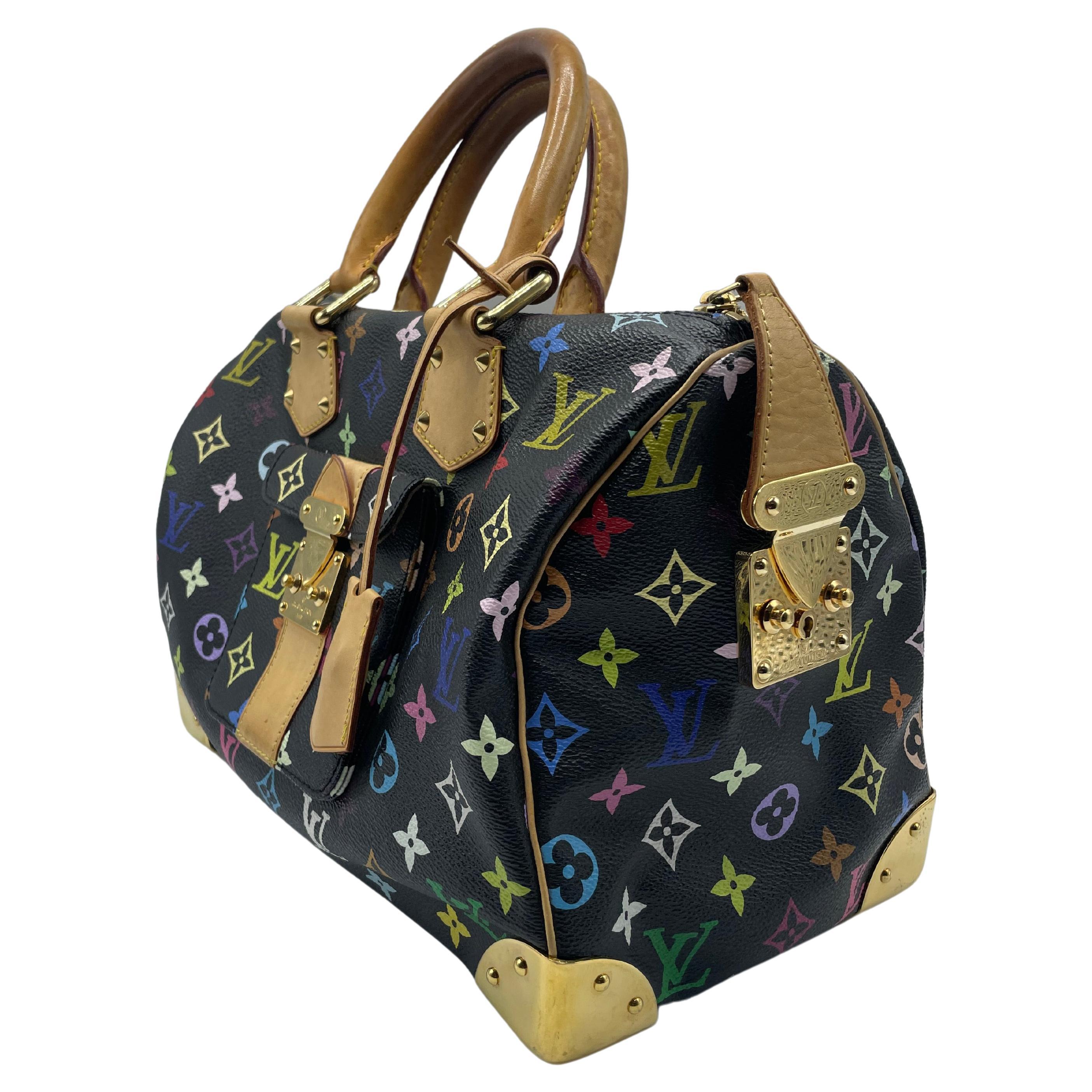 On black toile canvas, this Speedy bag has the Louis Vuitton Multicolore logo in 33 vibrant hues. This handbag has rolling handles made of vachetta cowhide leather and polished brass hardware, including solid handle rings, a press lock on the