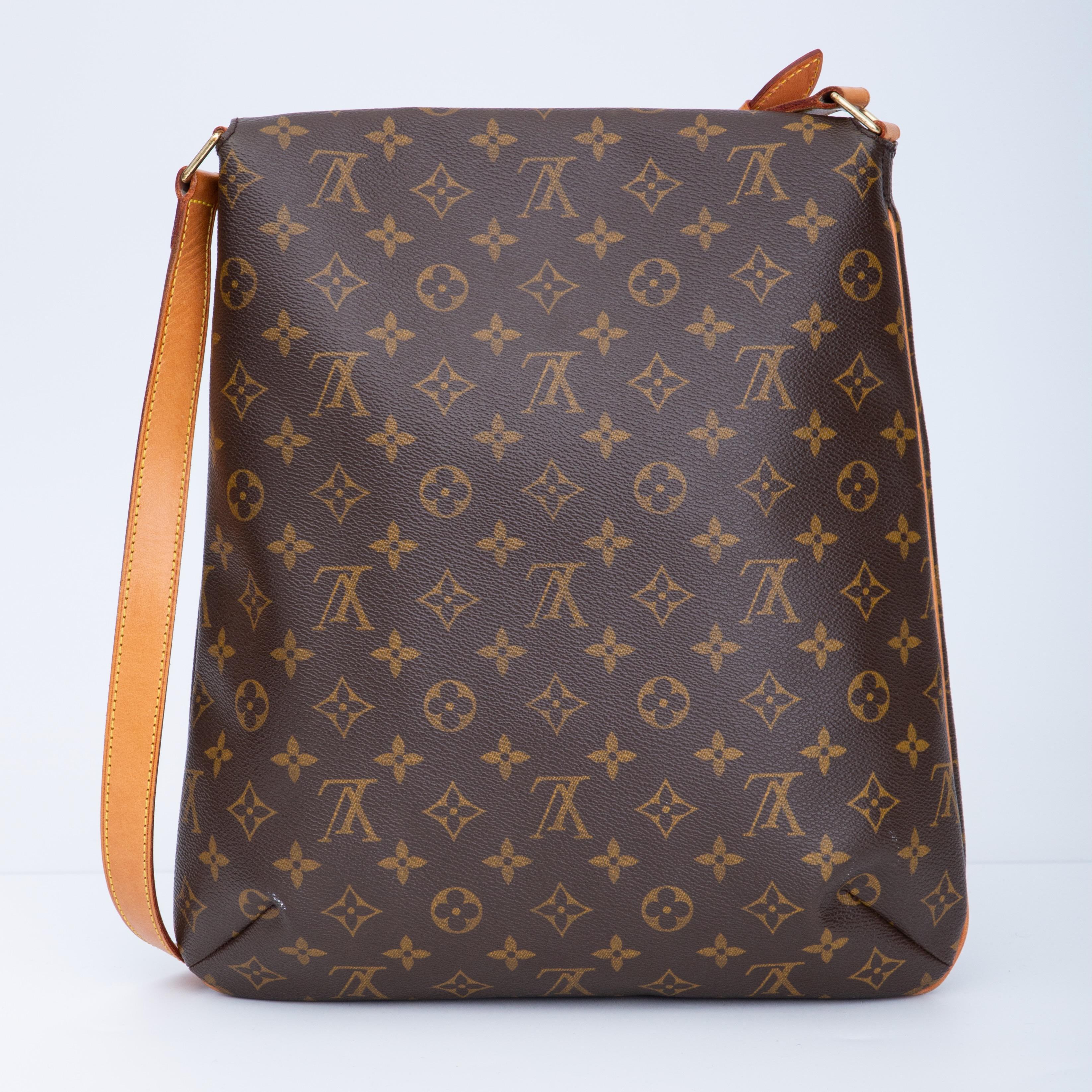 This bad is made of coated canvas with lv's monogram print with a long natural leather shoulder strap. The bag features brass hardware, tan vachetta leather details, a single adjustable flat shoulder strap, marigold alcantara interior lining, cross