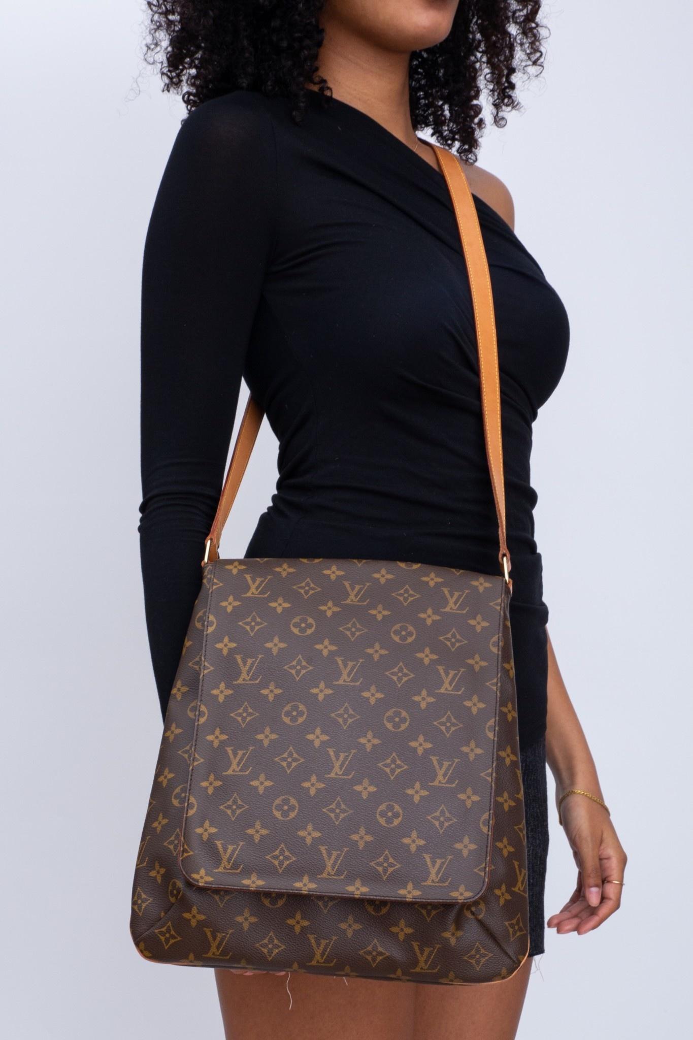 The bad is made of coated canvas with monogram print with a long natural leather shoulder strap. The bag features brass hardware, tan vachetta leather details, a single adjustable flat shoulder strap, marigold alcantara interior lining, cross grain