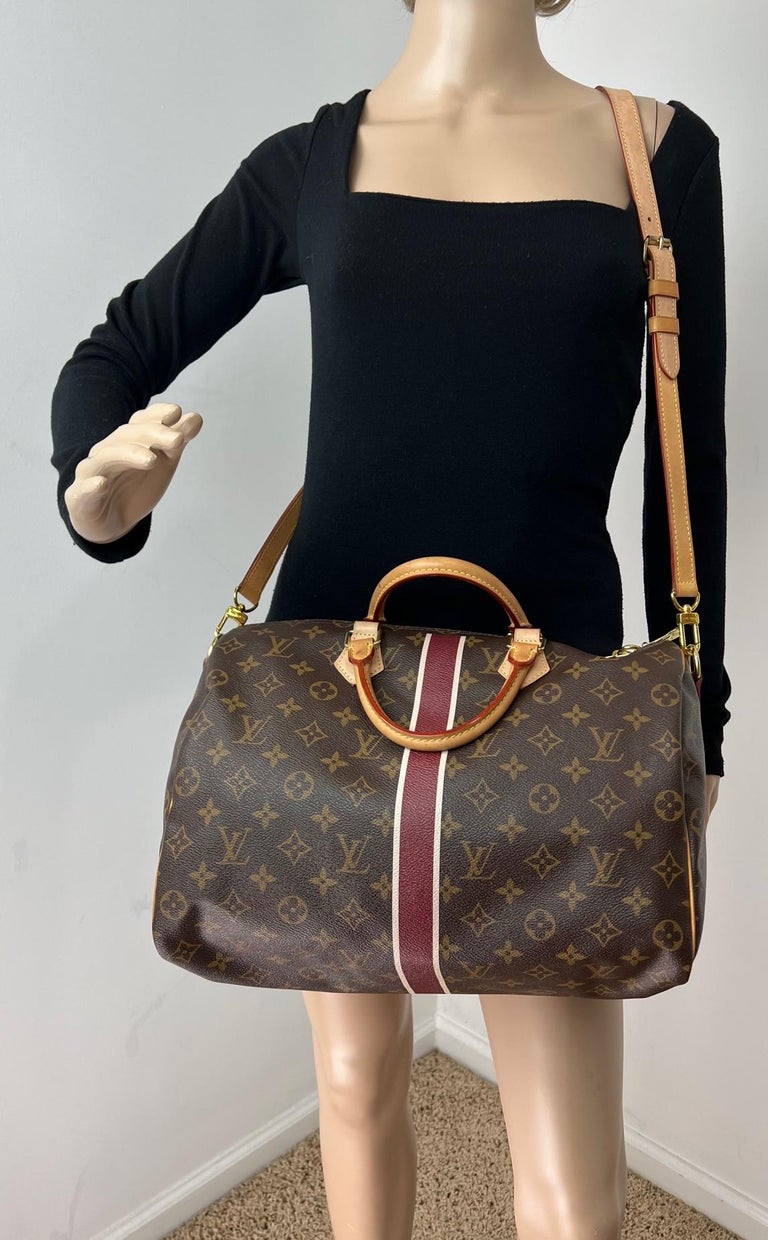Pre-Owned  100% Authentic
Louis Vuitton Monogram MY LV Heritage
Speedy Bandouliere 35 W/added insert to
help keep its shape and organize
 RATING: A B   very good, well maintained, shows minor
signs of wear
MATERIAL: monogram canvas
LEATHER TRIM: has