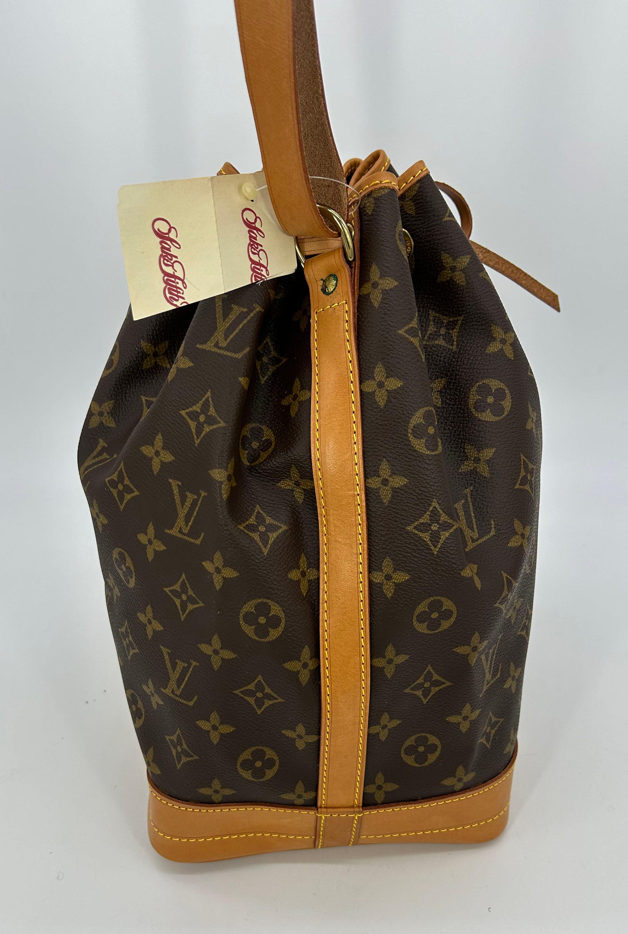 Louis Vuitton Monogram Noe in very good condition. Signature monogram canvas exterior trimmed with tan leather and golden brass hardware. Top leather adjustable shoulder strap. Tan leather base. Top drawstring bucket style closure opens to an