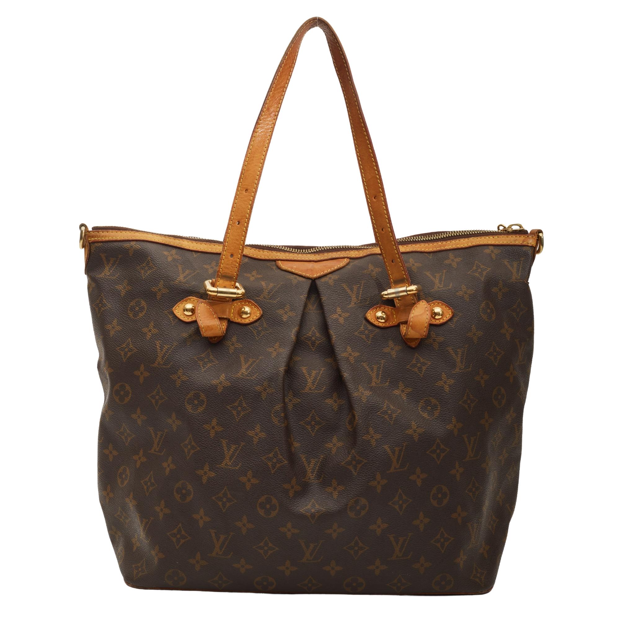 This tote is made of classic Louis Vuitton monogram print on toile canvas. This bag features dual vachetta cowhide flat leather top handles, gold tone hardware, top zip closure, a Louis logo zipper pull and natural leather finishes throughout. The