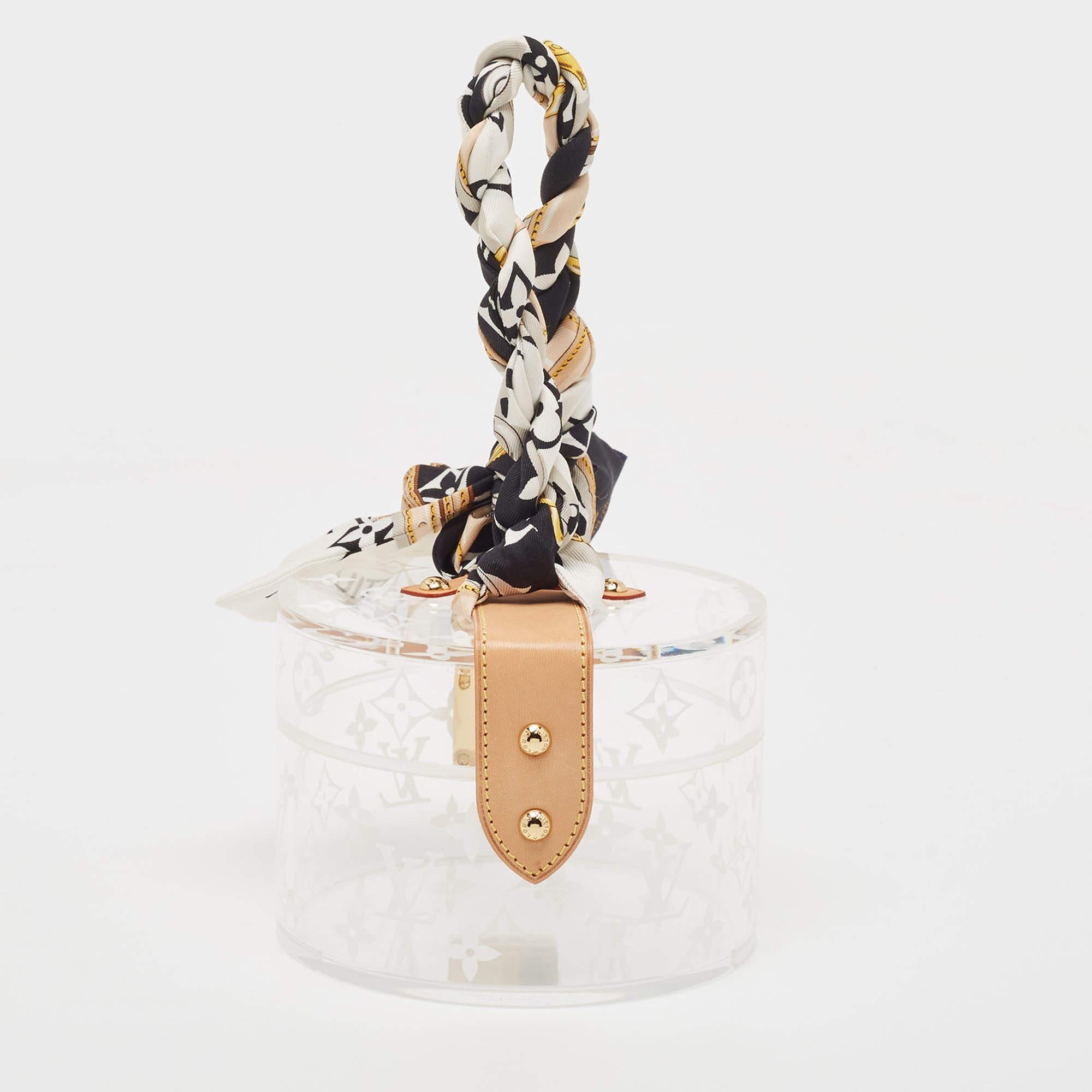 The Box Scott by Louis Vuitton is crafted using the label’s signature Monogram plexiglass. It features a rounded silhouette, front S-lock, and leather trim. Make it part of your dressing table, or choose it as a gift as it also comes with a twilly.

