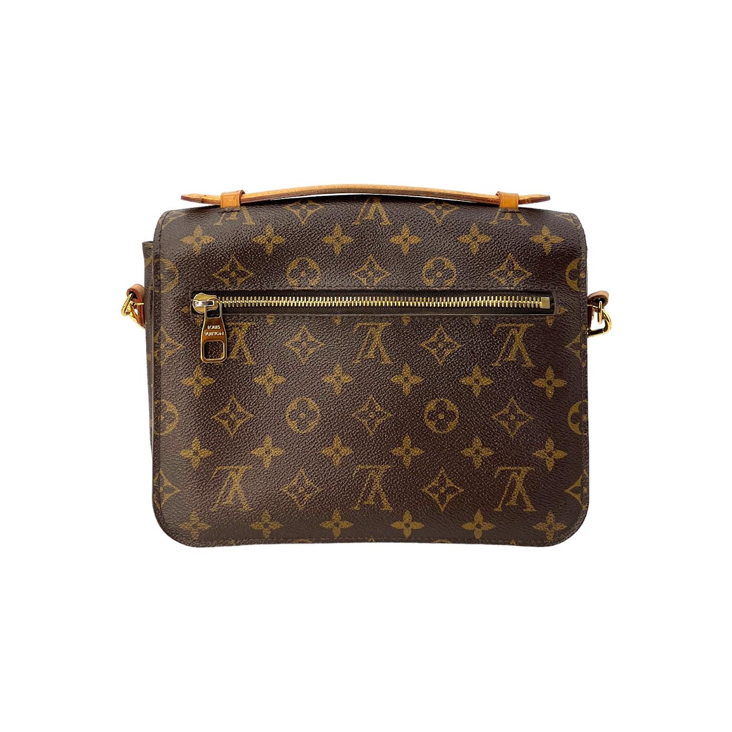 This Louis Vuitton Monogram Pochette Métis was made in France in 2017 and it is finely crafted of the iconic Louis Vuitton Monogram coated canvas exterior with leather trimming and gold-tone hardware features. It has a flat leather top handle. It