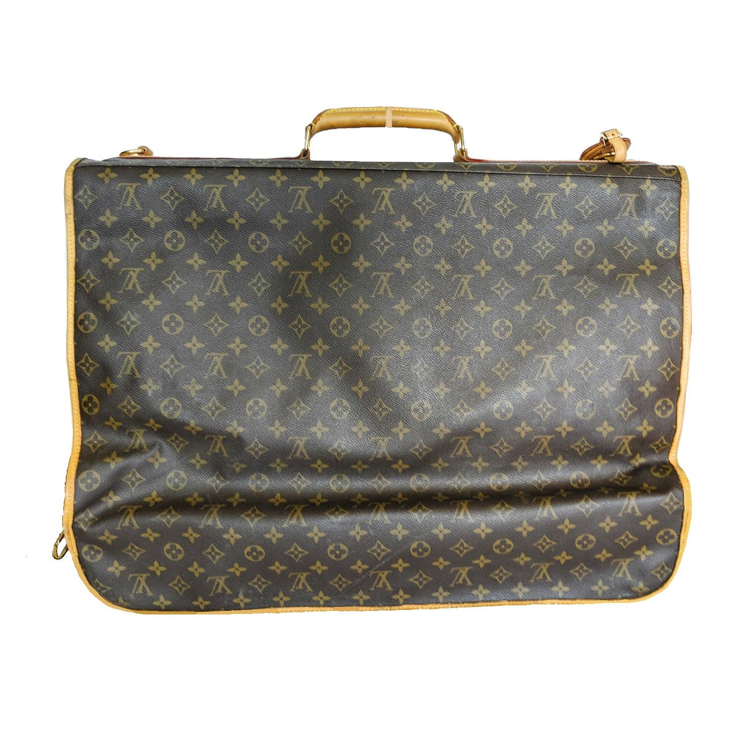 Brown and tan monogram coated canvas Louis Vuitton Portable Bandoulière with brass hardware, tan vachetta leather trim, detachable flat shoulder strap, single rolled top handle, hanging hook at top, exterior zip pocket at back, chocolate woven