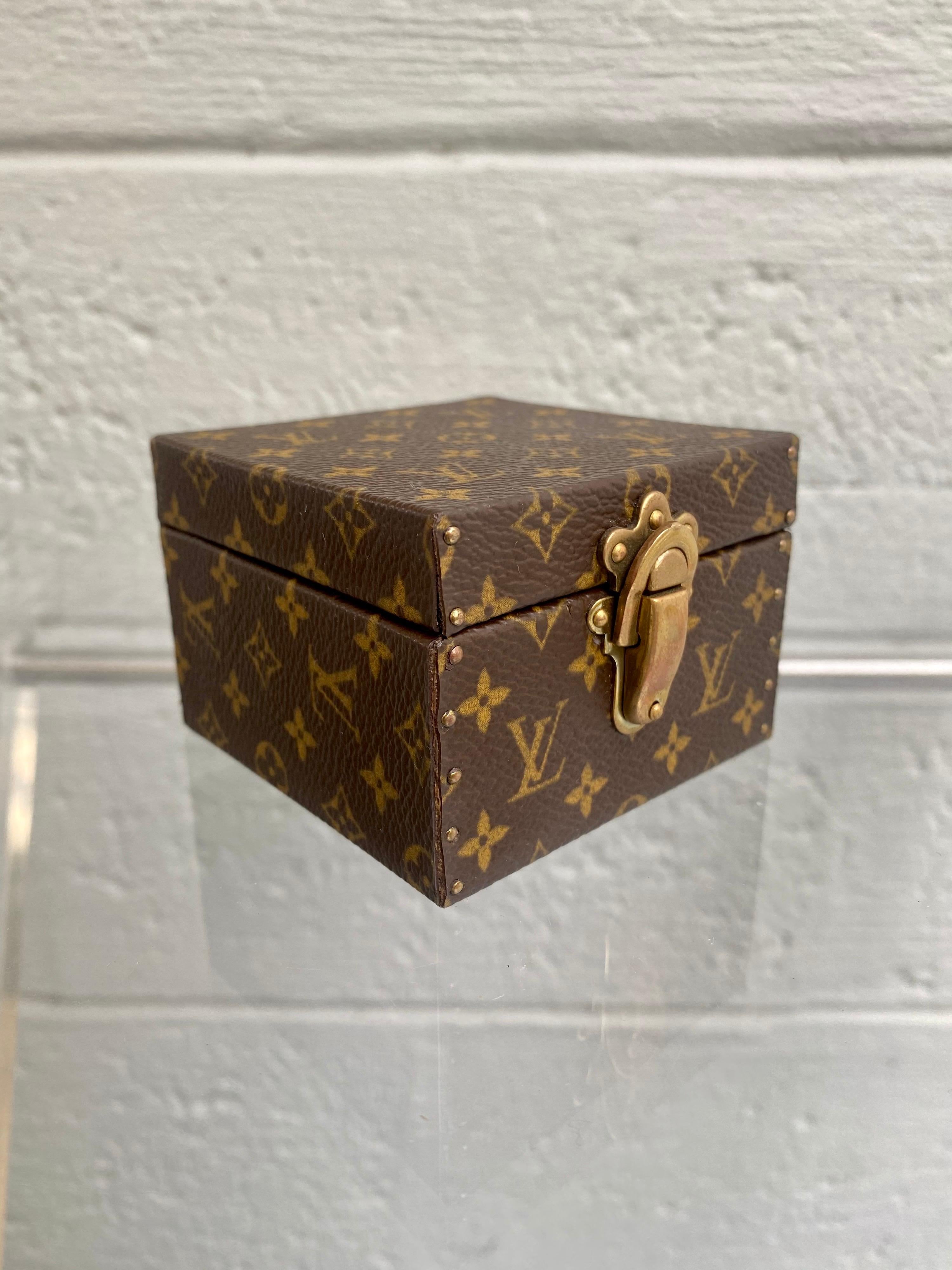 An exceptional min trunk case for romantic gifts. Classic Monogram designed for declarations of true love. Ideal for an engagement ring or other jewelry, this exquisite case proves that sometimes the container is as precious as what is inside.