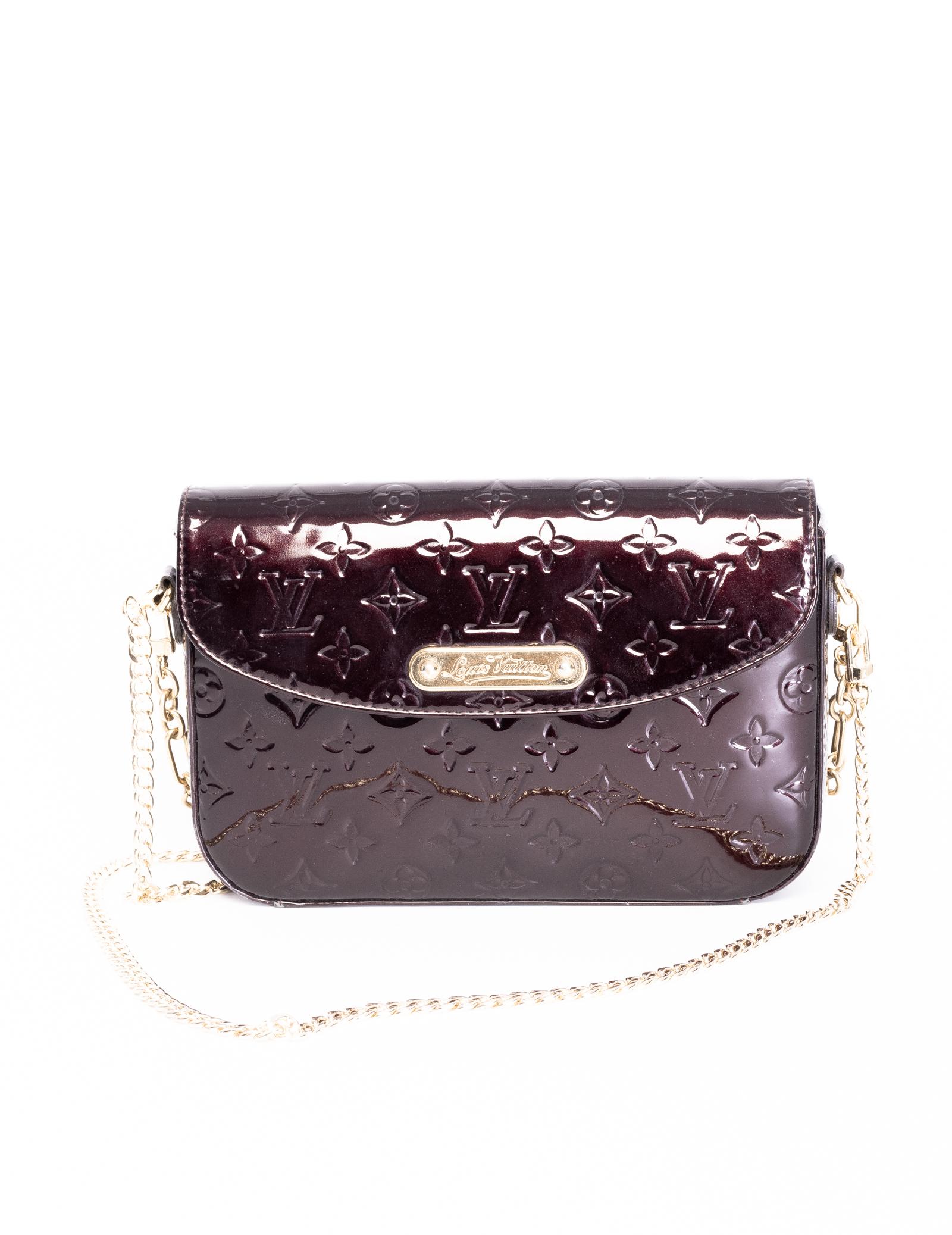 This style of patent leather monogram embossed bags are named Vernis as the French word for varnish is “vernis”.  Vernis was introduced by Marc Jacobs in 1998. 
This bag is made of calfskin leather embossed with monogram print and coated with a