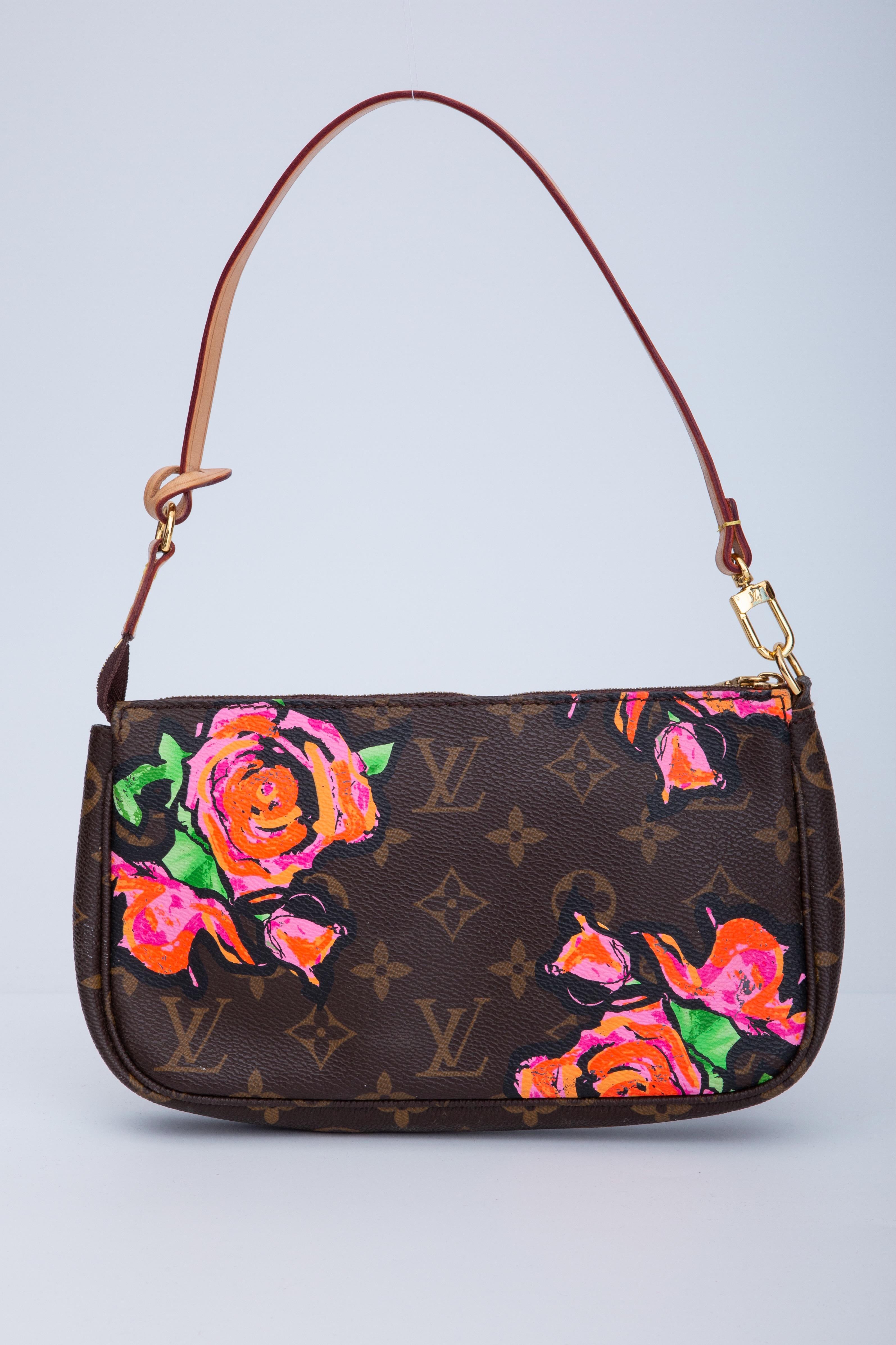 This limited edition Pochette Accessories bag is designed by Stephen Sprouse. The bag is made of traditional Louis Vuitton monogram on coated canvas with a vibrant print of decorative abstract roses in pink, orange, and green. The bag features a