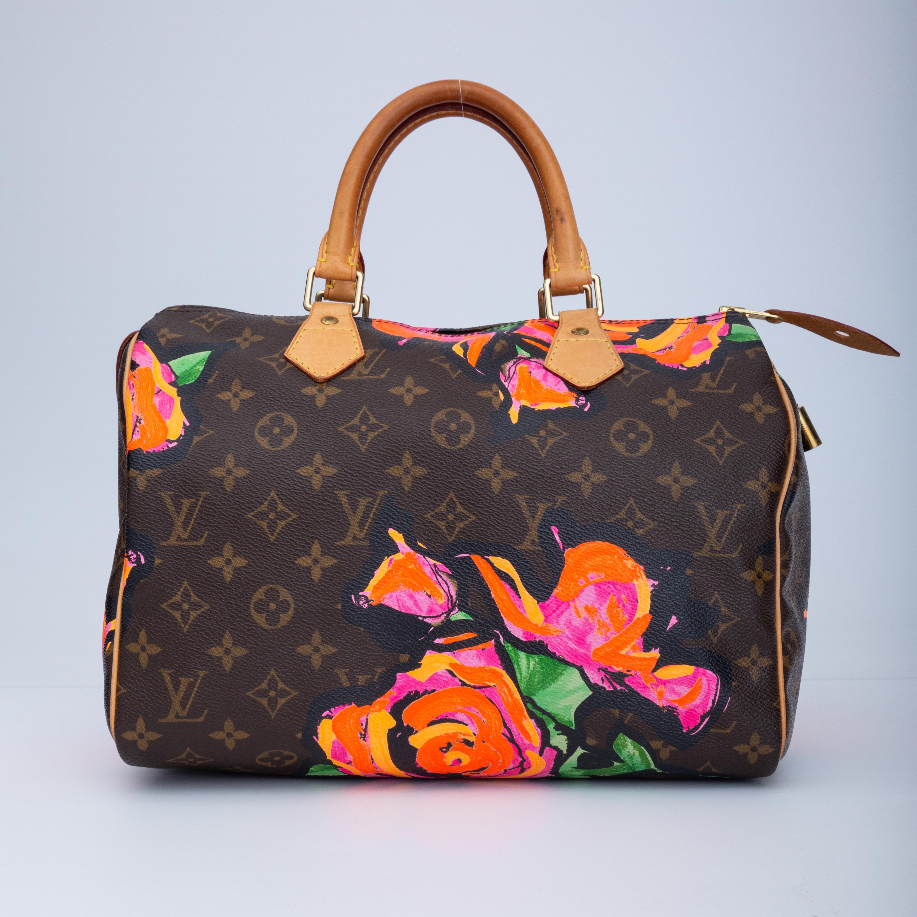 This limited edition Speedy bag is designed by Stephen Sprouse. The bag is made of traditional Louis Vuitton monogram on coated canvas with a vibrant print of decorative abstract roses in pink, orange, and green. The bag features vachetta rolled
