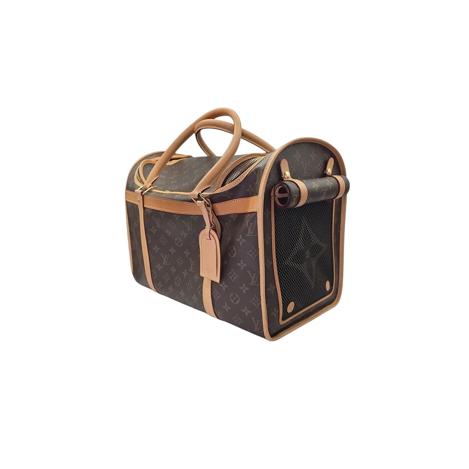 Travel with sophistication and ease with this Louis Vuitton Monogram Sac Chien Pet Carrier. This new model fur baby bag is crafted with luxurious monogram canvas and cowhide leather trim, it features a breathable mesh front, convenient washable