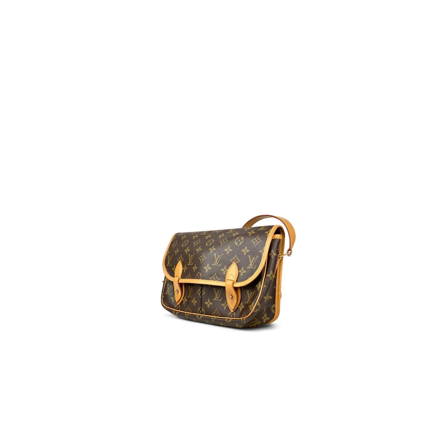 Brown and tan monogram coated canvas Louis Vuitton Sac Gibeciere MM with

- Brass hardware
- Tan Vachetta leather trim
- Single flat shoulder strap with buckle adjustment
- Single slit pocket at exterior back
- Dual slip pockets at flap underside,