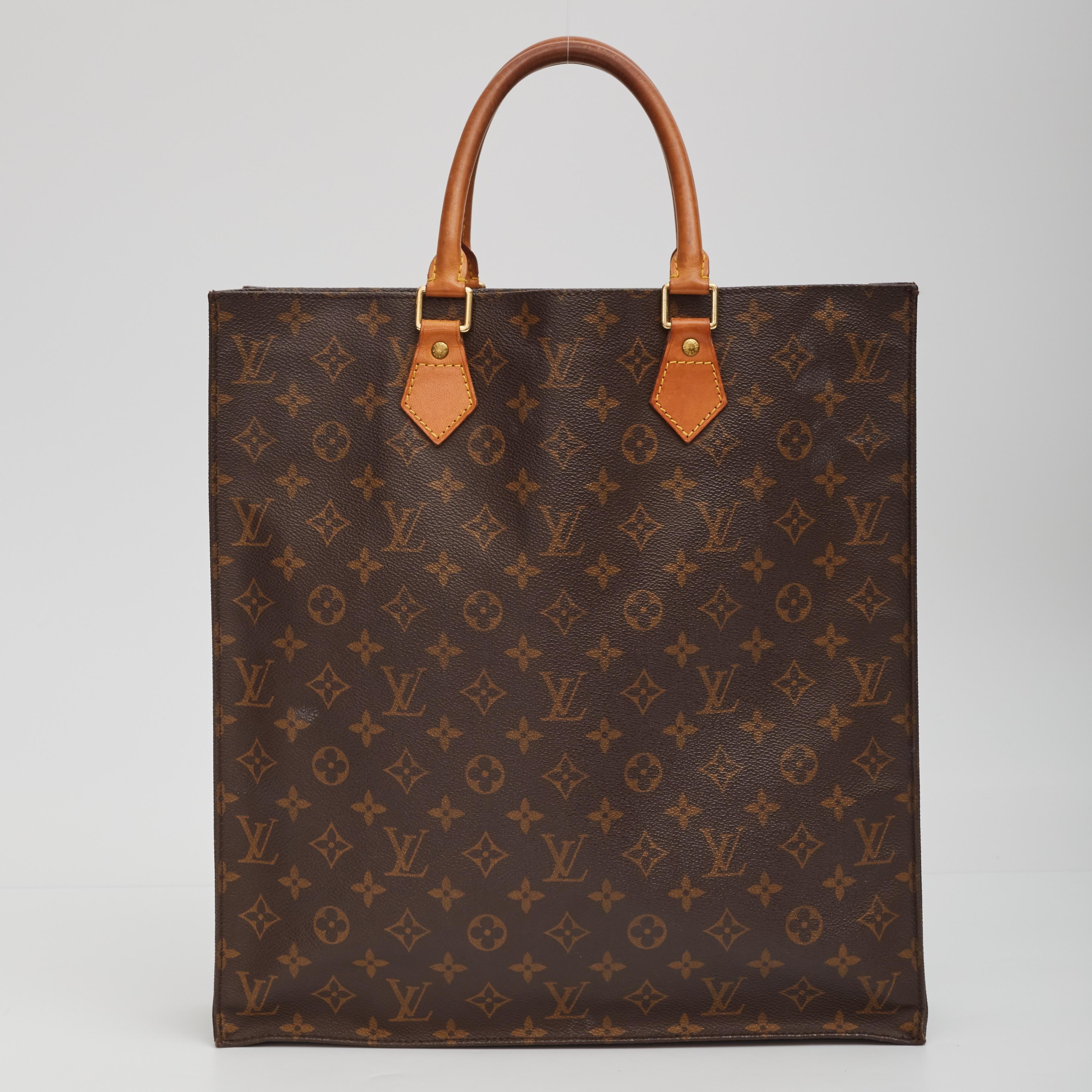 This handbag is made of classic Louis Vuitton monogram print on toile canvas. The bag features dual rolled vachetta leather top handles, brass hardware, an open top, ivory vuittonite leather lining with patch pockets.

Color: Brown
Material: Coated