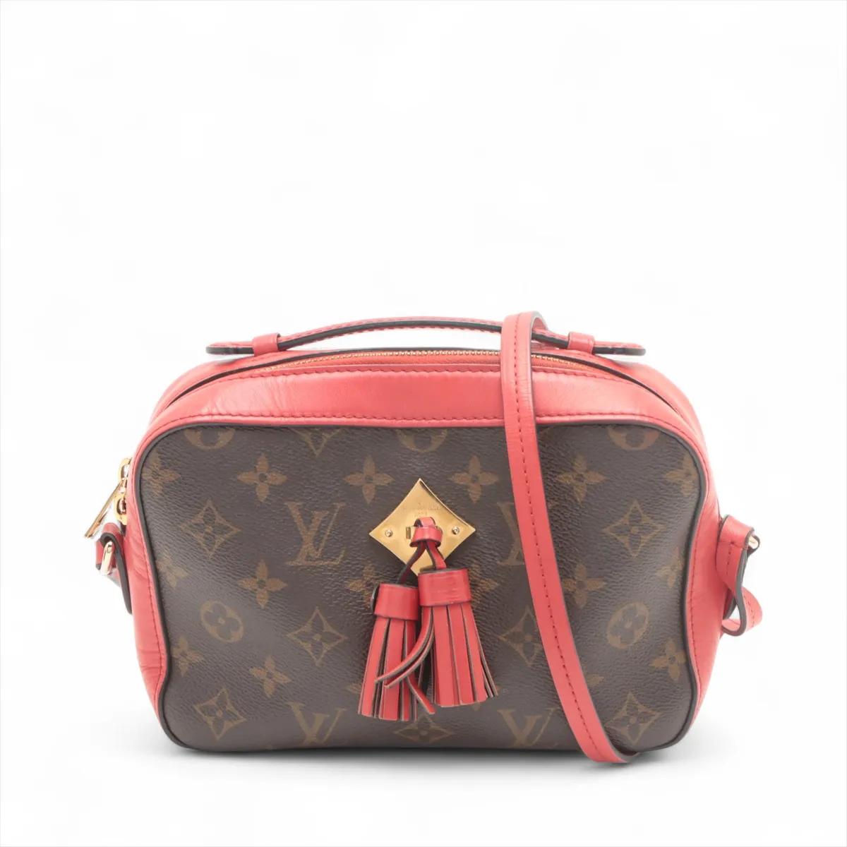La Louis Vuitton Monogram Saintonge in marrone e rosso è una borsa crossbody elegante e compatta che unisce l'eleganza classica a un tocco di colore giocoso. Realizzata con l'iconica tela Monogram e accenti in pelle rossa, la borsa emana un fascino