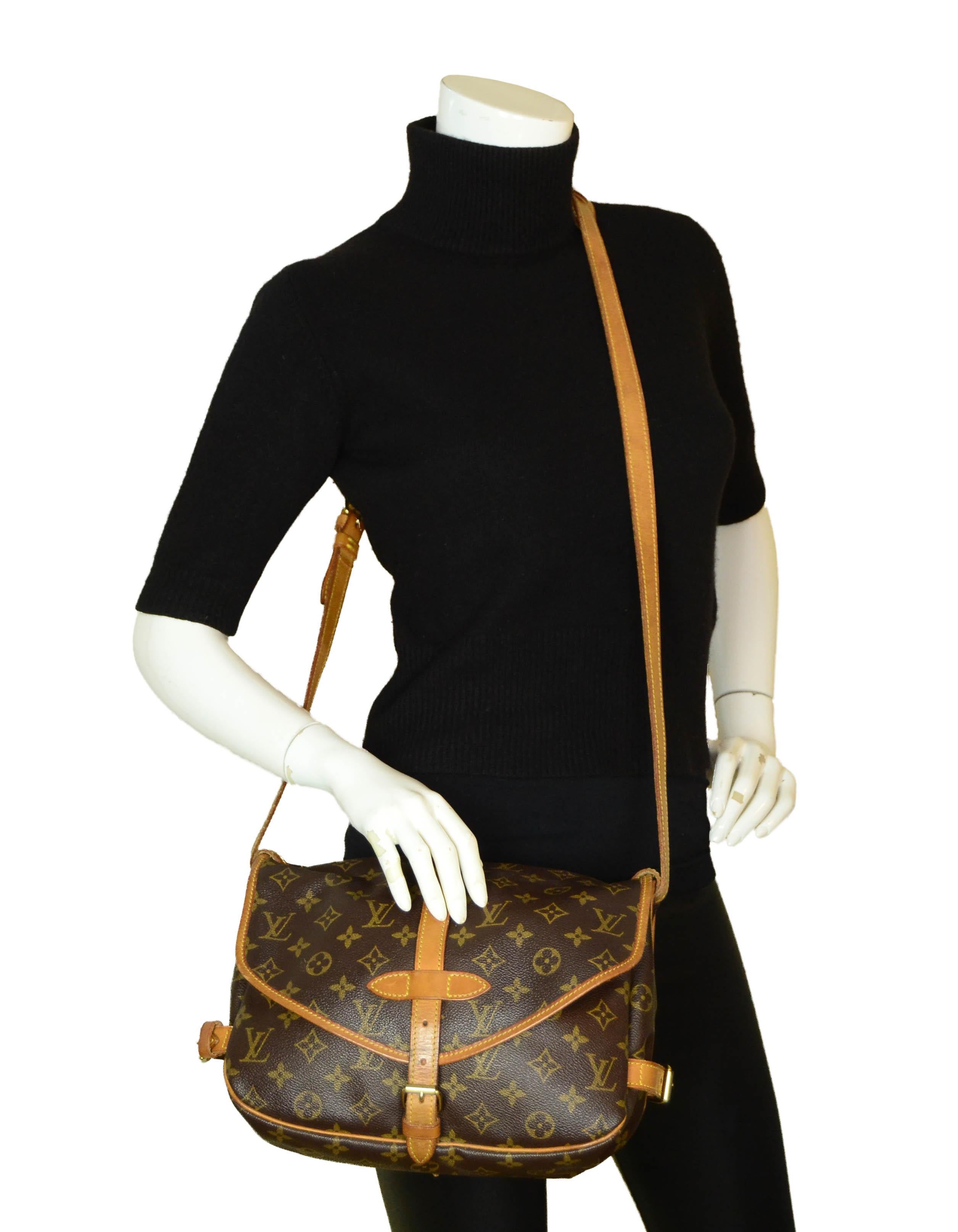 Louis Vuitton Monogram Saumur 30 Double Saddle Bag

Made In:France
Year of Production: 1993
Color: Brown monogram
Hardware: Goldtone
Materials: Coated canvas & vachetta leather
Lining: Canvas
Closure/Opening: Flap w/ strap & buckle
Interior Pockets: