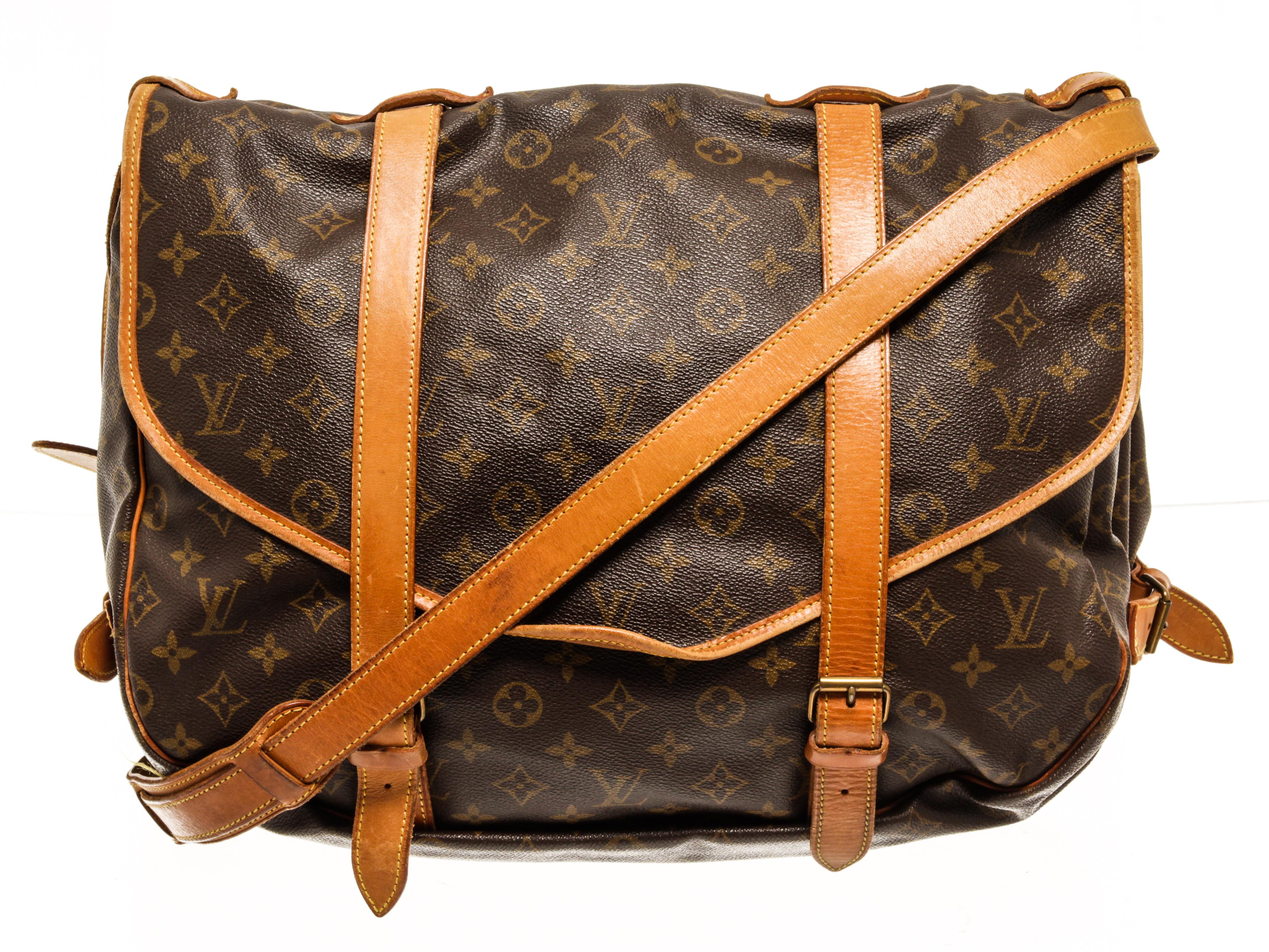 Louis Vuitton Monogram Saumur 43 shoulder bag with coated canvas exterior, brown fabric lining, contrasting vachetta leather trims and adjustable strap; gold-tone hardware, flap and buckle closure; and two main compartments, one on each