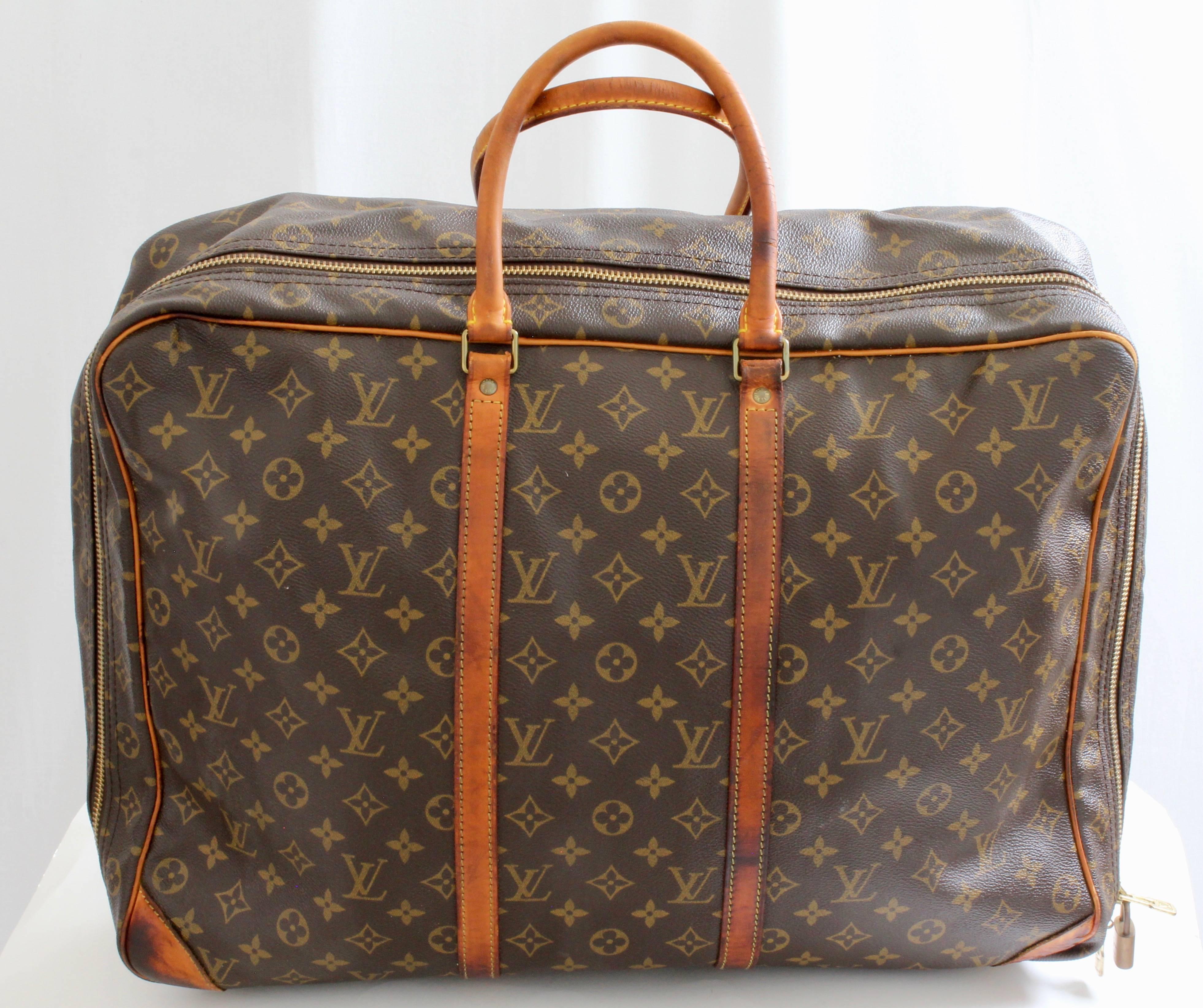 Travel in style with this vintage Louis Vuitton Monogram Sirius 50cm suitcase, made in 1989 and now discontinued in this size.  Made from their signature monogram canvas, it features rolled leather handles, a roomy interior with open pocket and