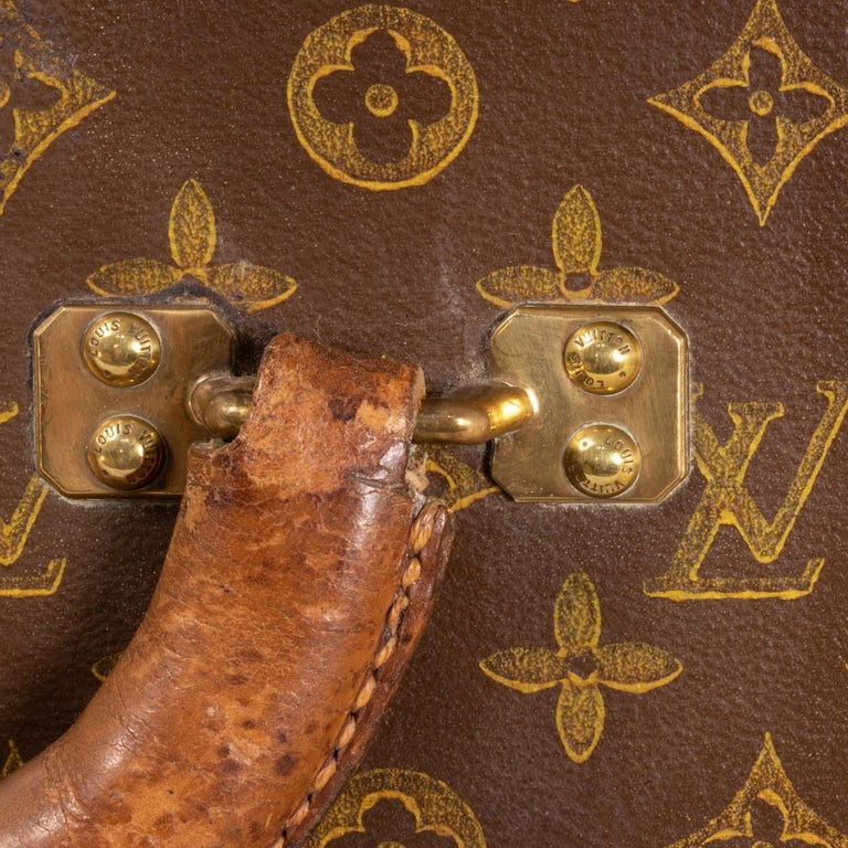Louis Vuitton monogram suitcase trunk open by center, square handle.