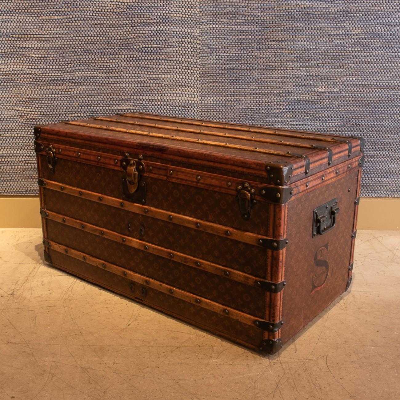 A lovely Louis Vuitton steamer trunk in monogram canvas with leather trim, patinated brass handles and fittings and original interior; minus the original trays, circa 1905.

Louis Vuitton was founded by its namesake in 1854, with the first shop on