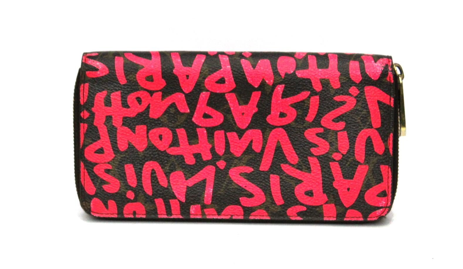  The wallet is a standard size clutch wallet crafted of classic Louis Vuitton monogram on toile canvas with an extra layer of graffiti inspired print of the Louis Vuitton name, here in neon pink (fuchsia). The wallet has a 3/4 wrap around zipper.