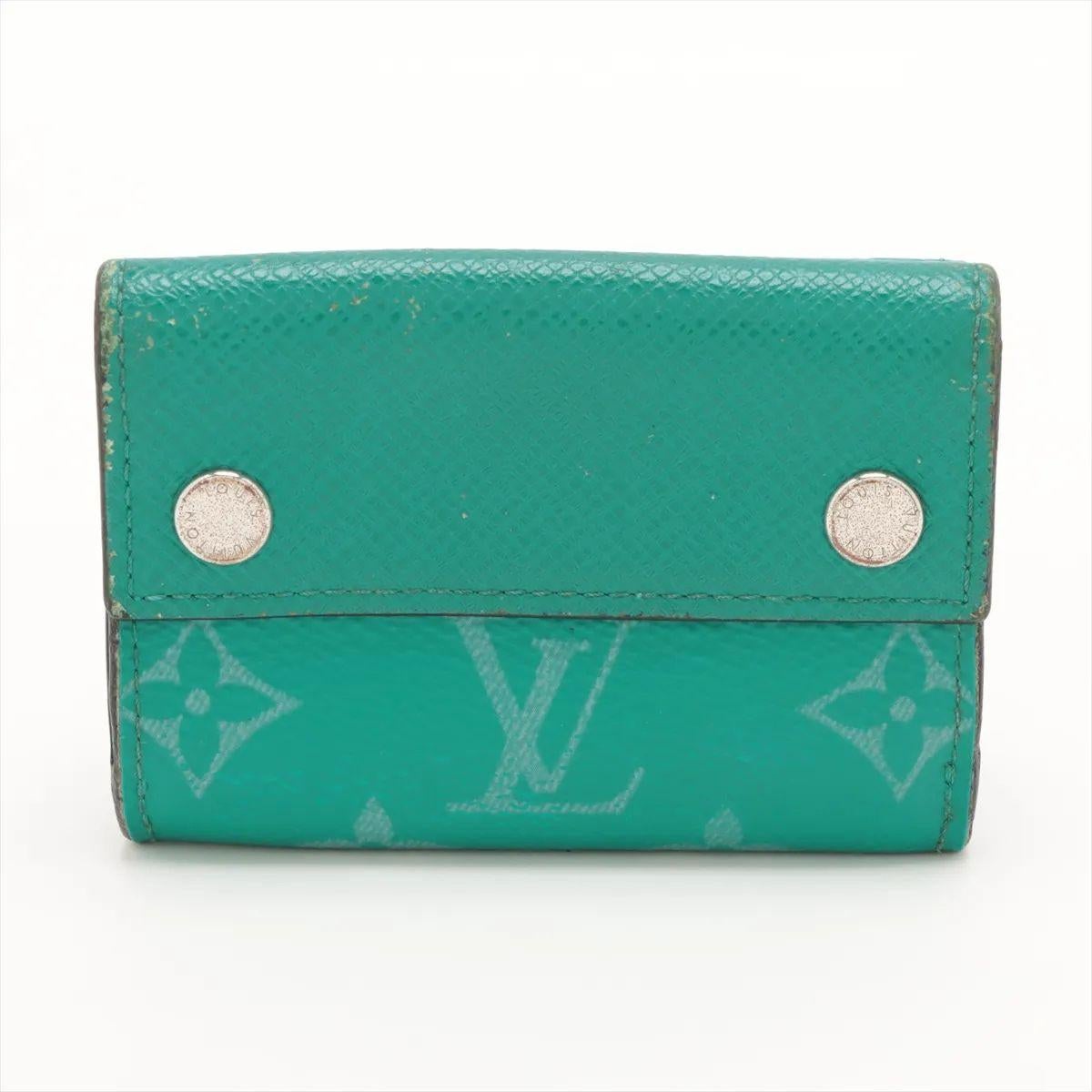 Die Louis Vuitton Monogram Taigarama Discovery Compact Wallet in Grün ist ein kühnes und funktionelles Accessoire, das den typischen Stil mit modernem Flair verbindet. Das Portemonnaie ist aus einer Kombination aus Monogram Canvas und geschmeidigem