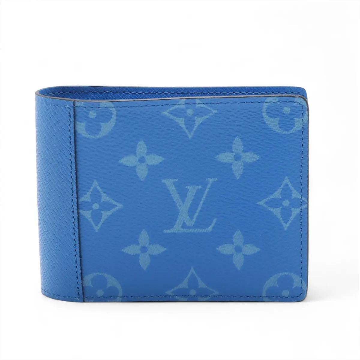 The Louis Vuitton Monogram Taigarama Portefeuille Multiple in Blue Lagoon is a stylish and practical wallet that combines elegance with modern functionality. Crafted from Monogram canvas paired with Taiga leather in a striking blue hue, it showcases