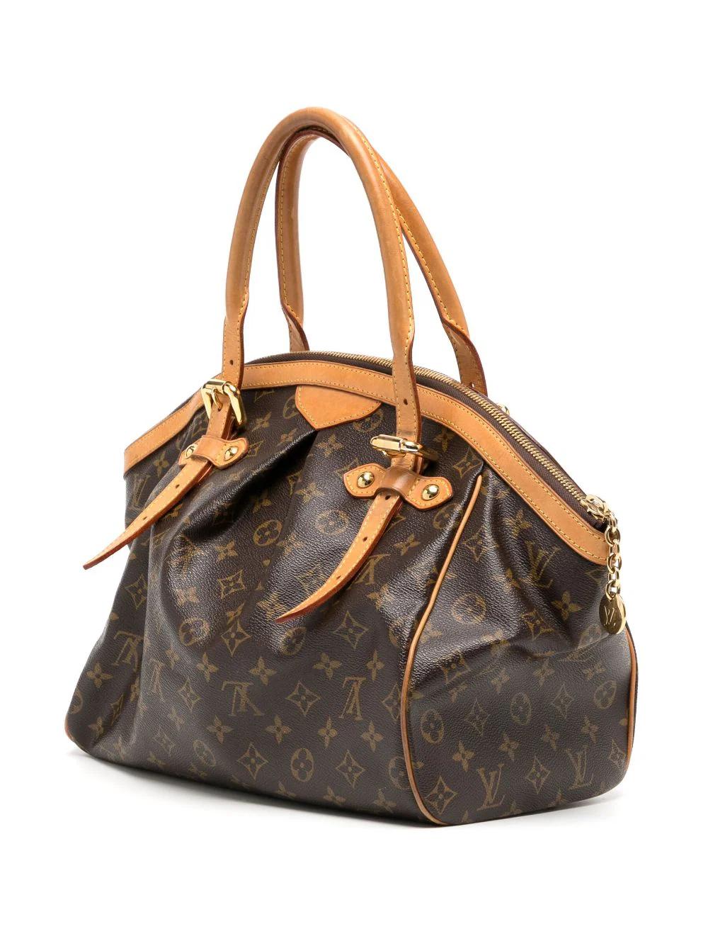Crafted in the iconic monogram canvas, the Louis Vuitton Tivoli GM shoulder bag is a timeless classic. Opens with a gold tone zipper LV pullon top and is lined in brown canvas with two open pockets against the back and one open pocket against the