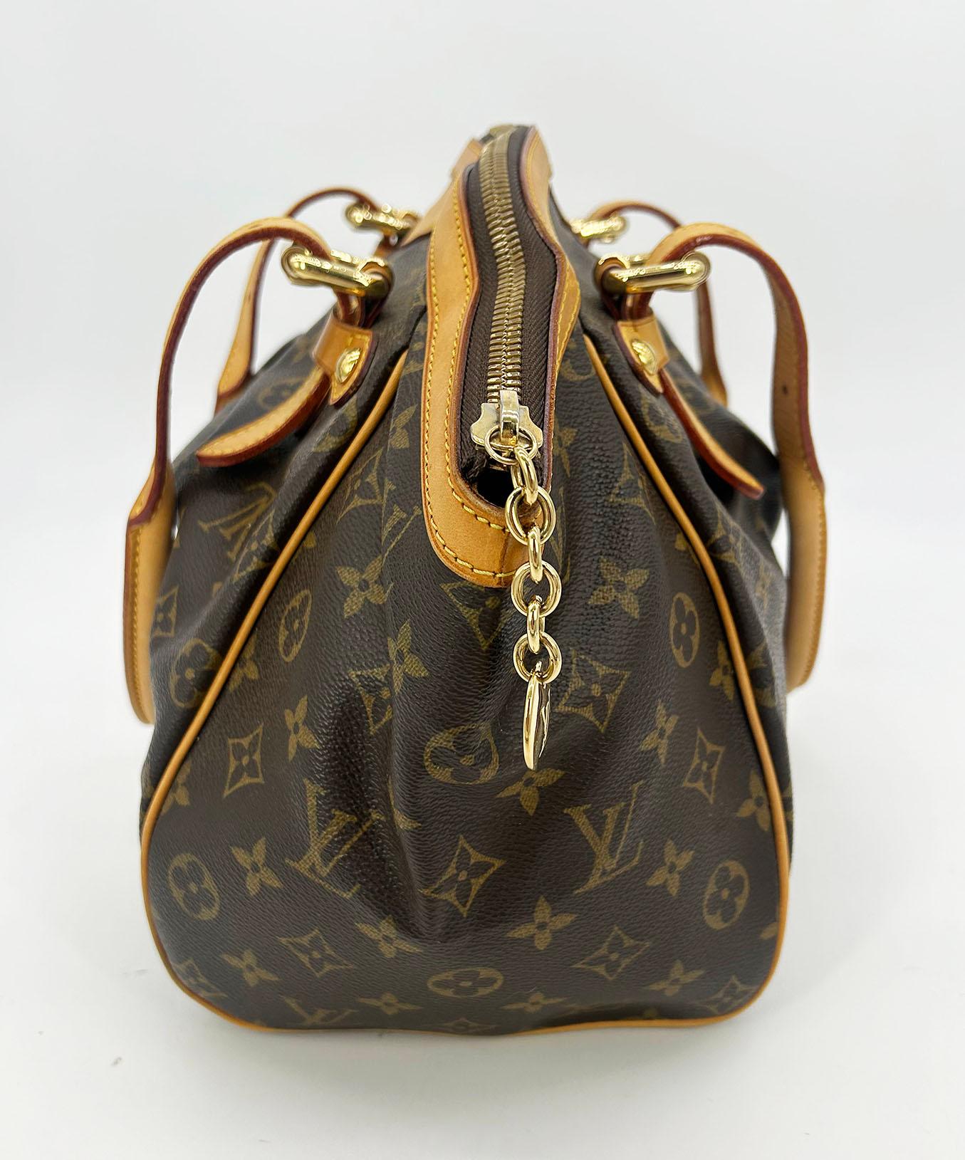 Louis Vuitton Monogram Tivoli GM in very good condition. Signature monogram canvas exterior trimmed with tan leather and gold hardware. Unique double top handle design with adjustable buckles at each end can be worn as a shoulder bag or carried by