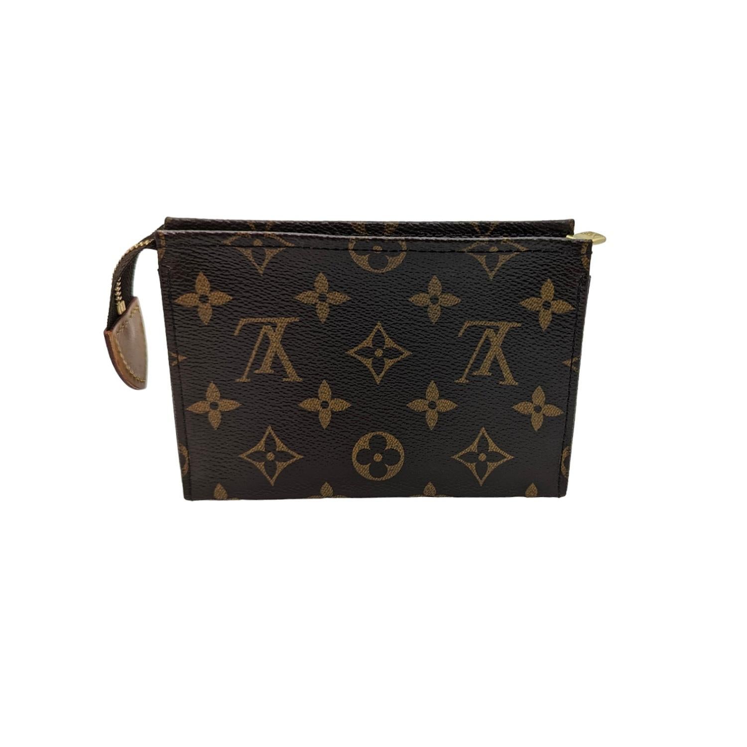 Louis Vuitton Monogram Toiletry Pouch 15. This cosmetics pouch is crafted of classic Louis Vuitton monogram coated canvas. The pouch features a polished brass top zipper that opens to an ivory interior.

Designer: Louis Vuitton
Material: Monogram