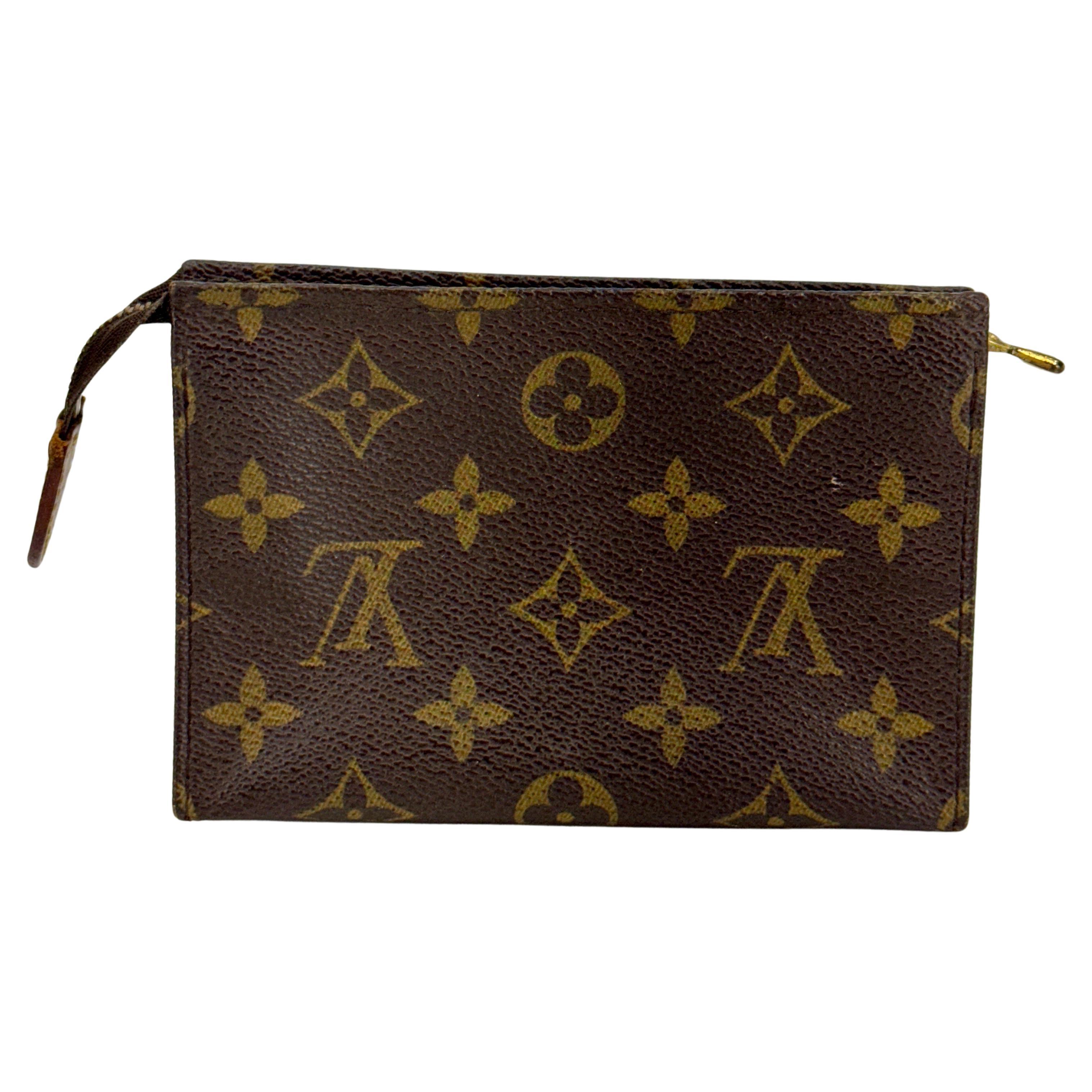 Monogram LV Toiletry Pochette Pouch 15 Date Code 881 TH, France

Authentic LOUIS VUITTON LV Monogram Toiletry Pouch 15. This cosmetic/ lipstick pouch or small carry-all is crafted of classic Louis Vuitton monogram coated canvas in brown. The pouch