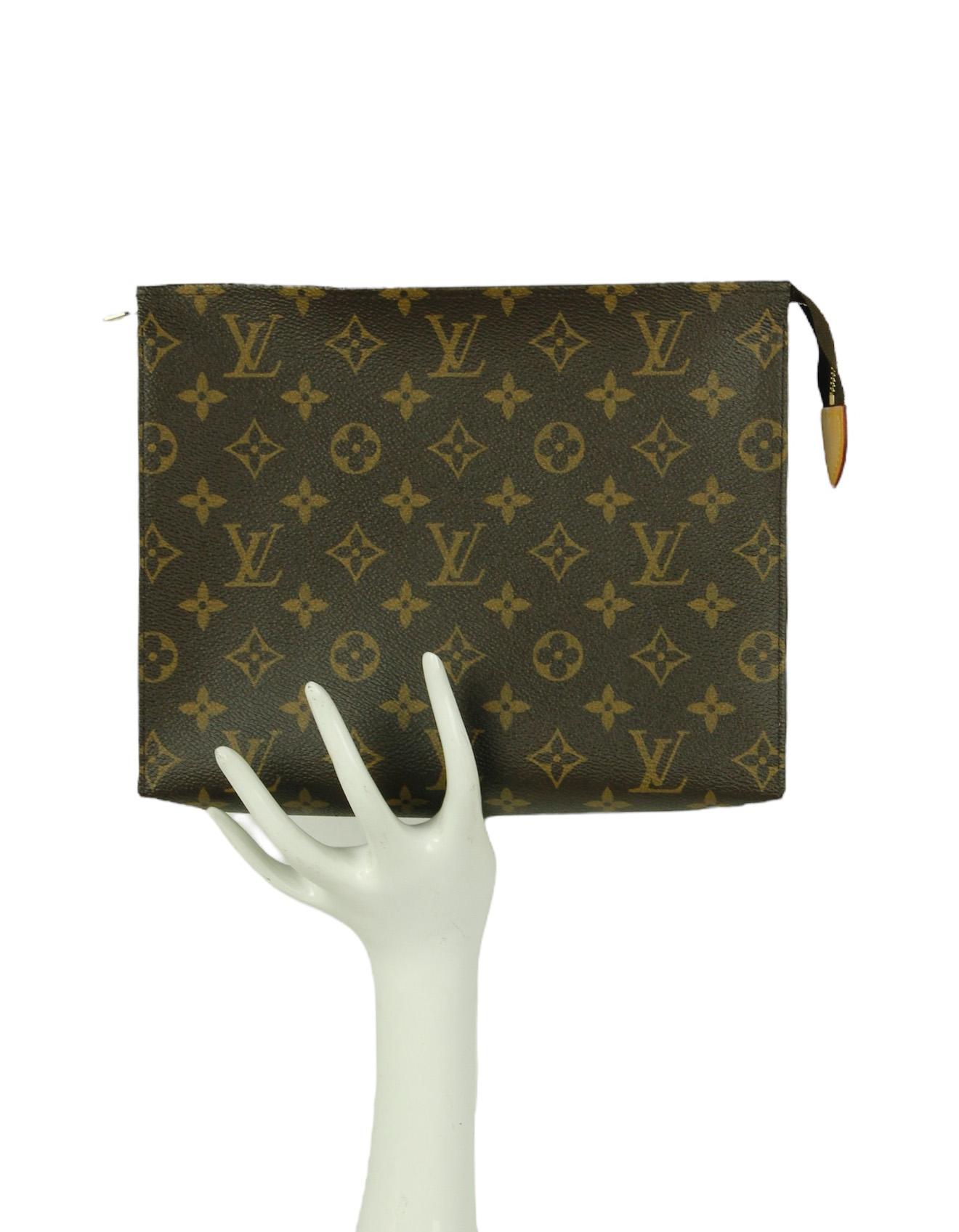 Louis Vuitton Monogram Toiletry Pouch 26 Cosmetic/Clutch Bag

Made In: France
Year of Production: 2016
Hardware: Goldtone
Materials: Coated canvas with natural cowhide-leather trim
Lining: Beige lining
Closure/Opening: Zip top
Interior Pocket: