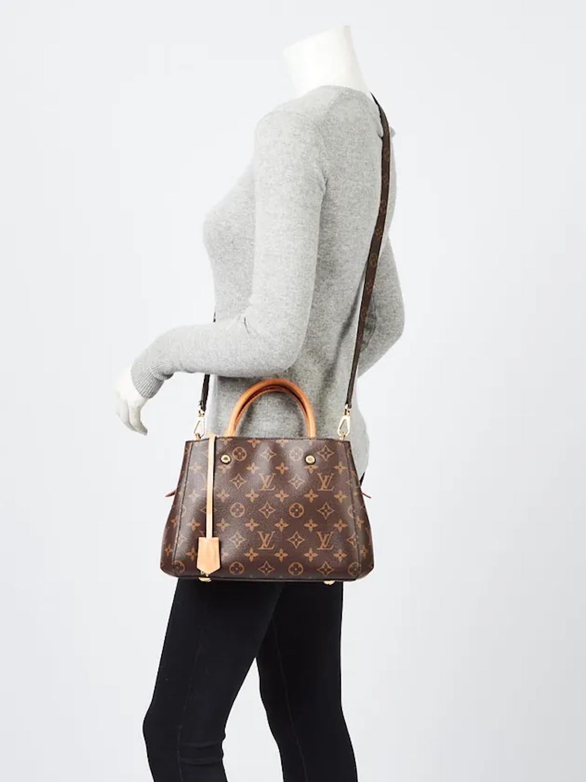 LOUIS VUITTON MONOGRAM TOP HANDLE MONTAIGNE BB BAG

This Louis Vuitton Montaigne BB is made of monogram-coated canvas with natural cowhide leather trim and gold-tone hardware. Inspired by the Parisian avenue it’s named after, the structured