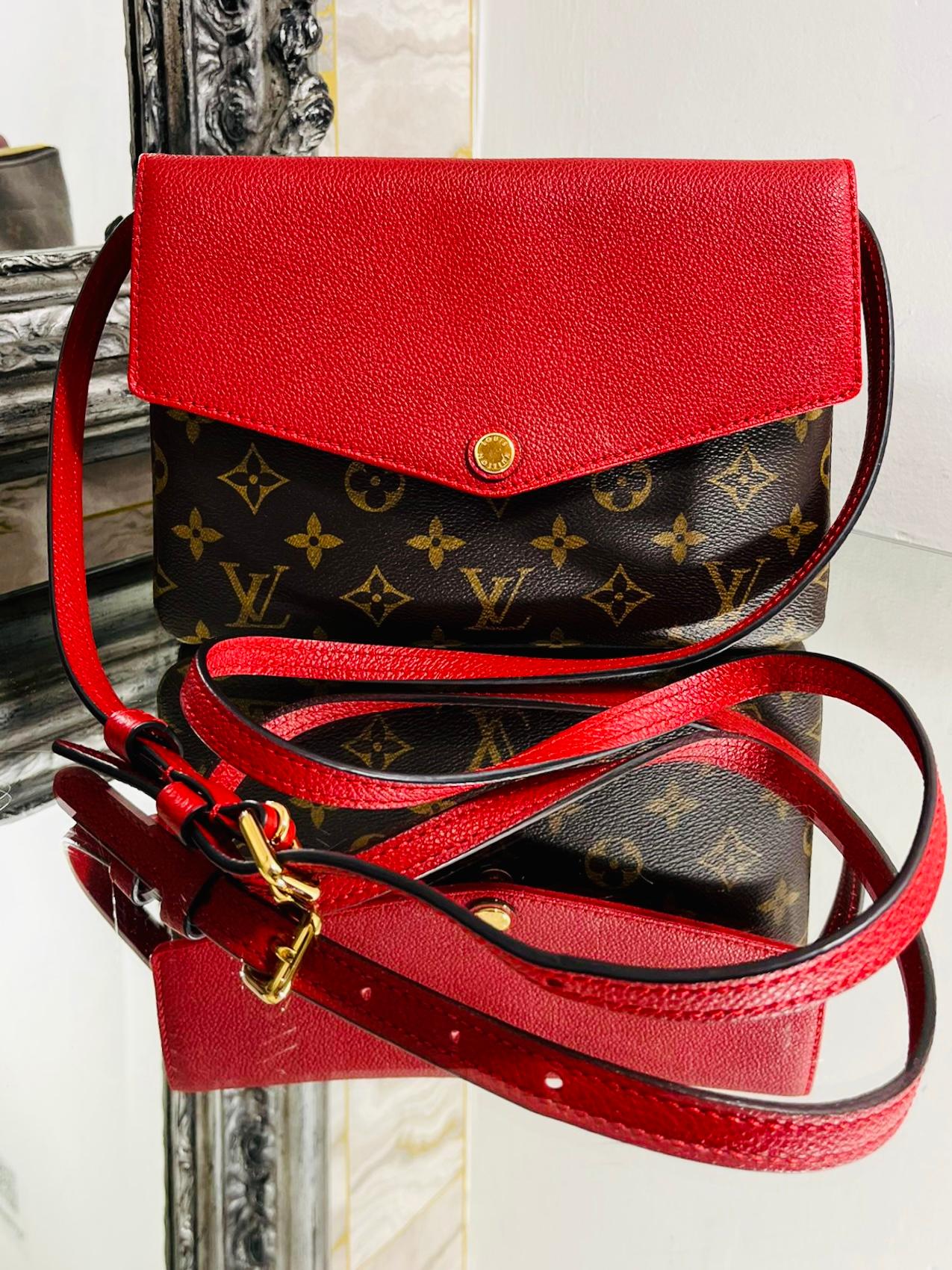 Louis Vuitton Monogram Twice Pochette Bag

'LV' logo monogram coated canvas with a leather cherry red flap closure

and matching shoulder/crossbody strap. Double compartments.

Size - Height 17cm, Width 23cm, Depth 6cm

Condition - Very