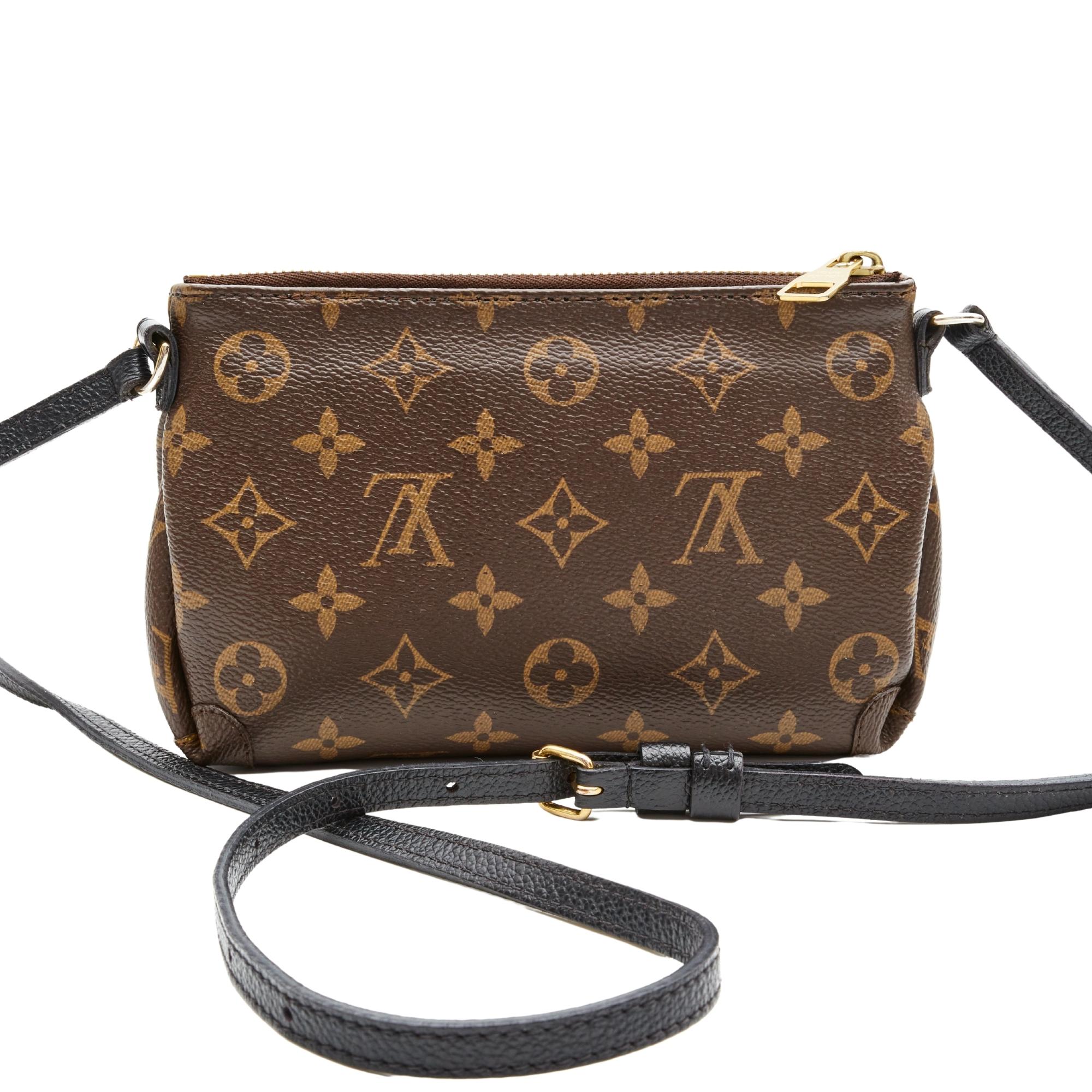 This uniform bag can be seen on sale assistants in LV stores and is made with brown monogram coated canvas. The bag features black leather finishes, gold-tone hardware, top zip closure and brown woven fabric interior lining with a large slip
