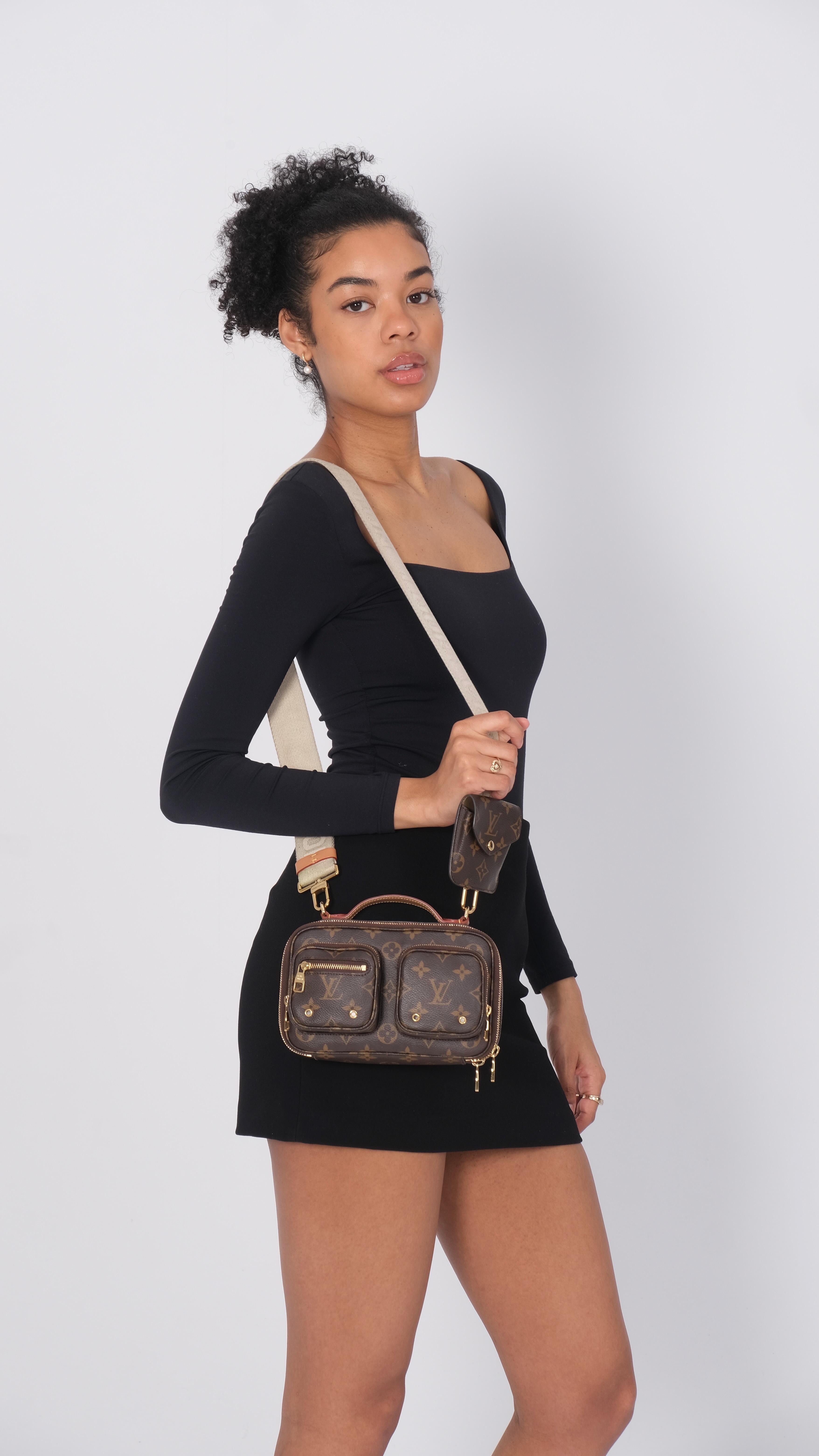 This chic crossbody bag is made of traditional monogram coated canvas. The bag features two front zipper compartments, a vachetta leather top handle, an optional, adjustable fabric shoulder strap, and a removable coin purse. The wrap-around zippers