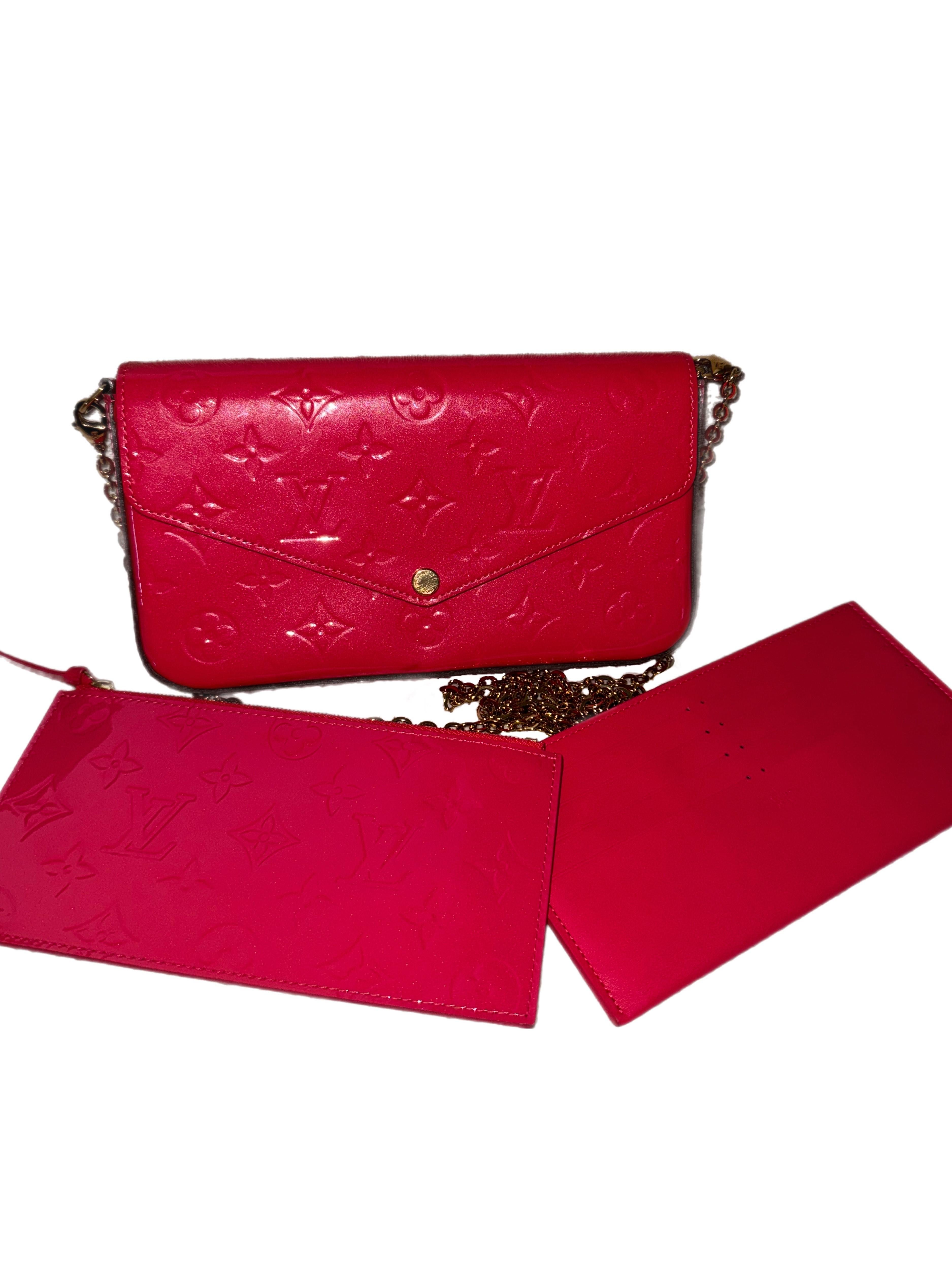 The Louis Vuitton Monogram Vernis Félicie Pochette in Cerise is a chic and versatile clutch crafted from glossy Monogram Vernis patent leather. Its sleek design features a snap-button closure, revealing a spacious interior with multiple