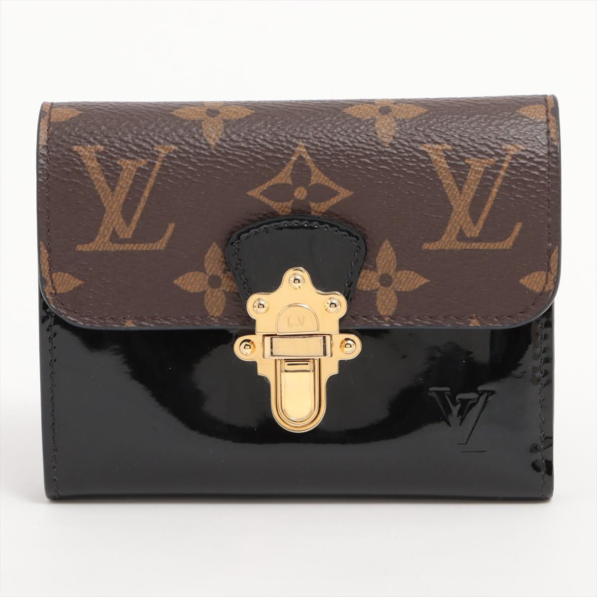 The Louis Vuitton Monogram Vernis S-Lock Short Wallet in Cherry Wood is a luxurious and chic accessory that effortlessly combines elegance with practicality. Crafted from a combination of Monogram Vernis patent leather and smooth leather, the wallet