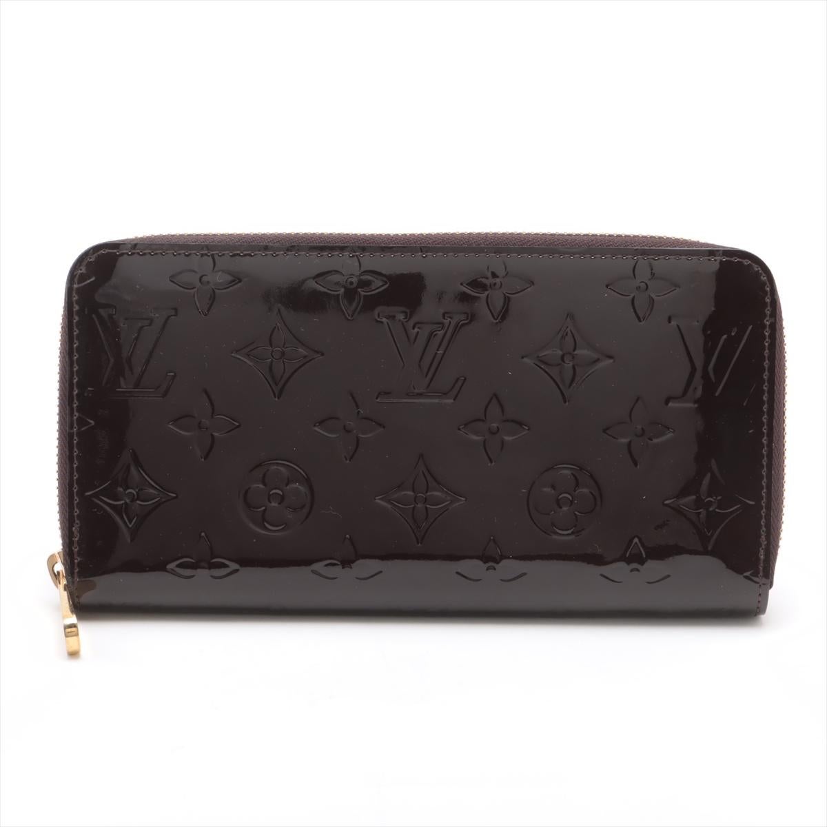 The Louis Vuitton Monogram Vernis Zippy Wallet in Amarante is a sophisticated and functional accessory crafted from glossy patent leather embossed with the iconic monogram pattern. The rich, deep purple hue called Amarante adds an elegant touch to