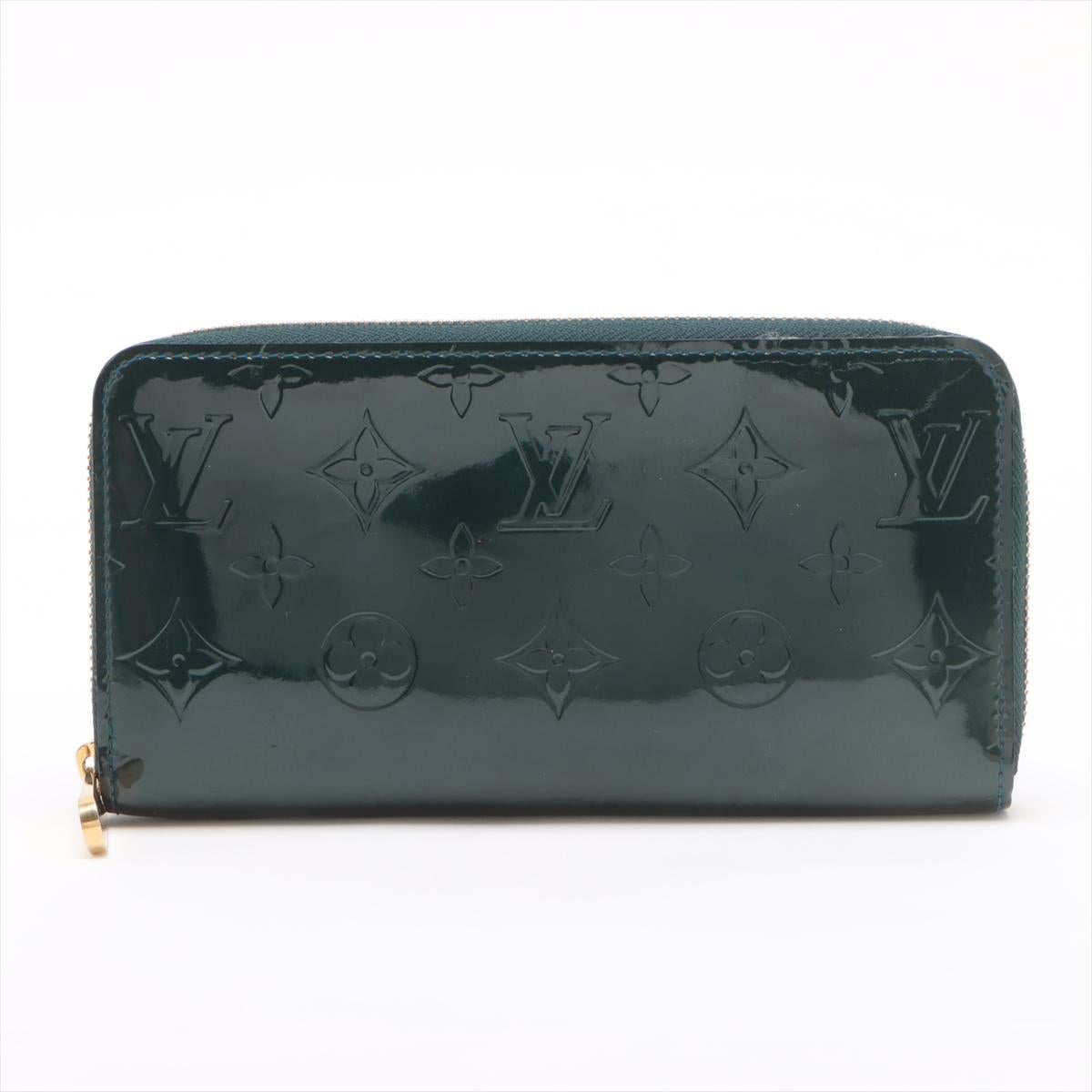 The Louis Vuitton Monogram Vernis Zippy Wallet in Bleu Nuit is a stunning blend of sophistication and functionality. Crafted from glossy Vernis patent leather embossed with the iconic Monogram pattern, the wallet exudes elegance with its deep blue