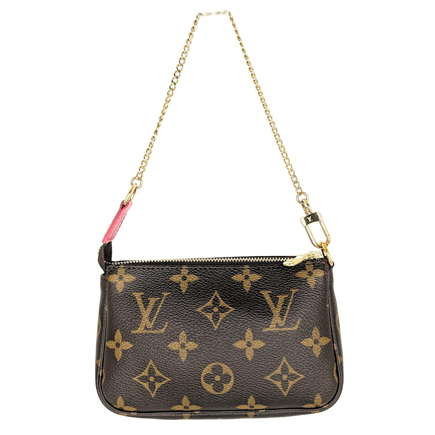 Brown and tan monogram coated canvas Louis Vuitton Mini Pochette Accessoires with gold-tone hardware, raspberry leather trim, single chain-link top handle, hand-painted multicolor Vivienne motif, raspberry canvas lining and zip closure at