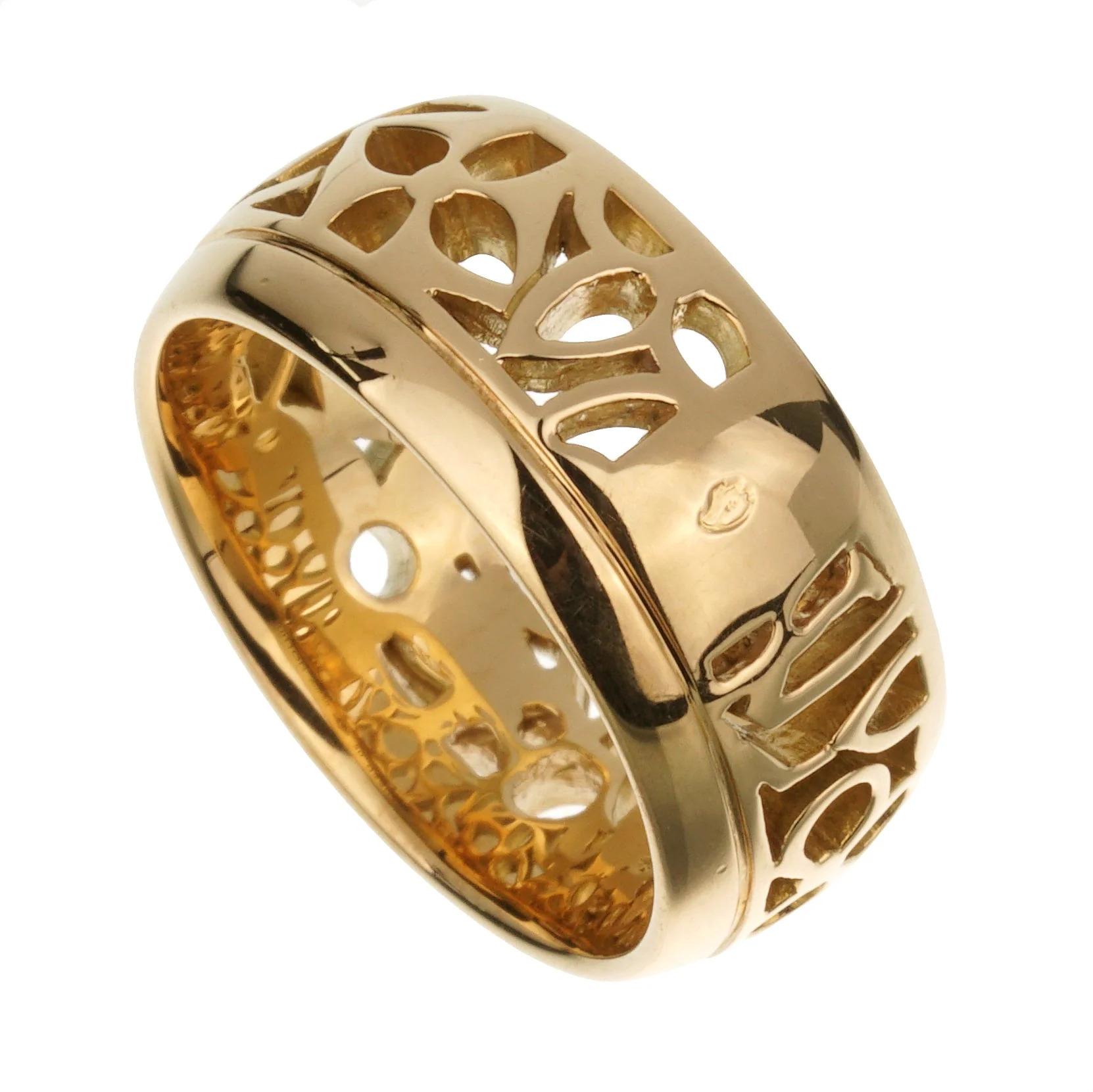 The intricate cut-out design provides a contrast between solid gold and negative space, allowing light to pass through the motifs. This gives the ring a lighter, almost ethereal quality while still maintaining its presence as a substantial piece of